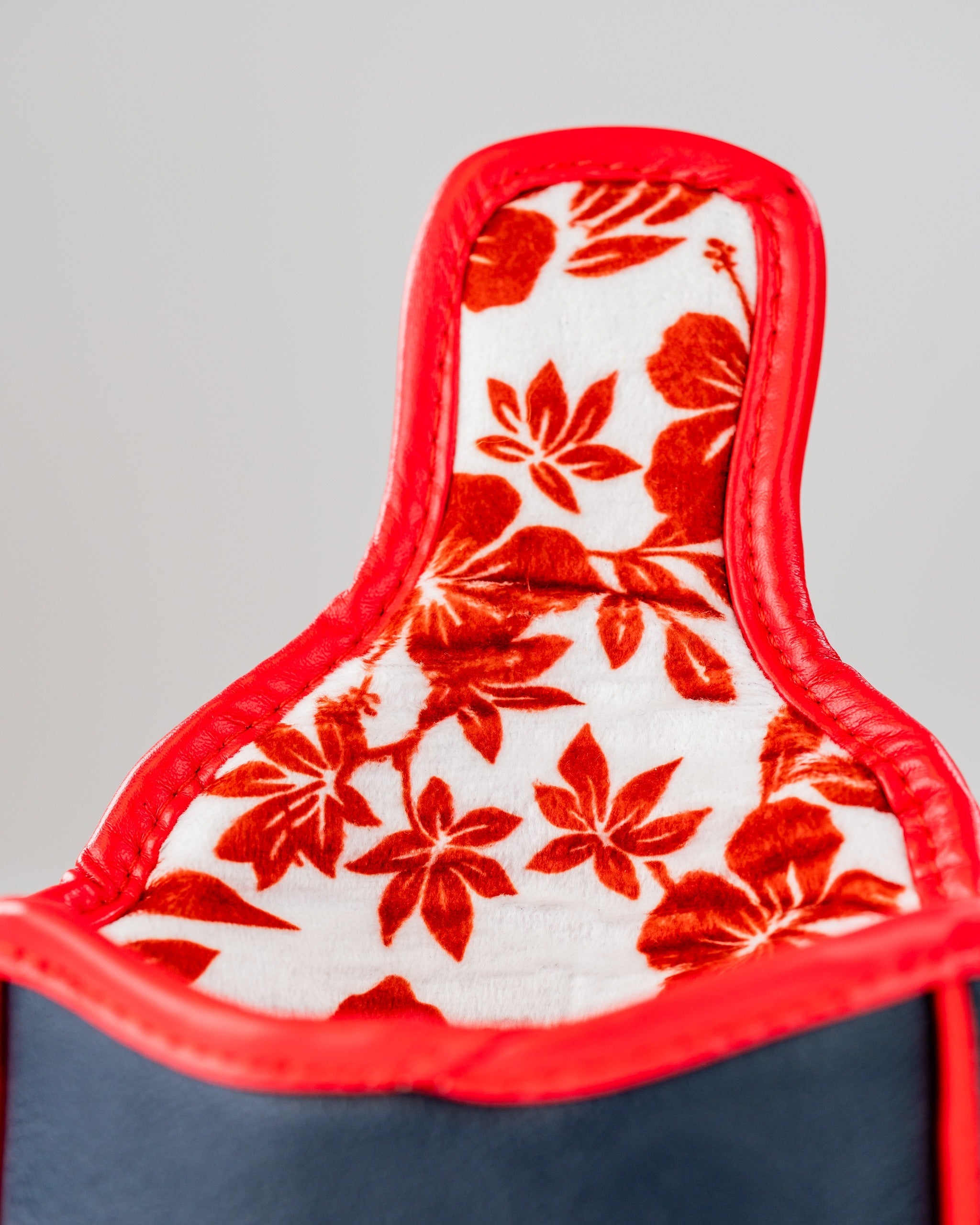 Interior view of a mallet putter cover featuring a floral pattern in red and white, designed for golfers.