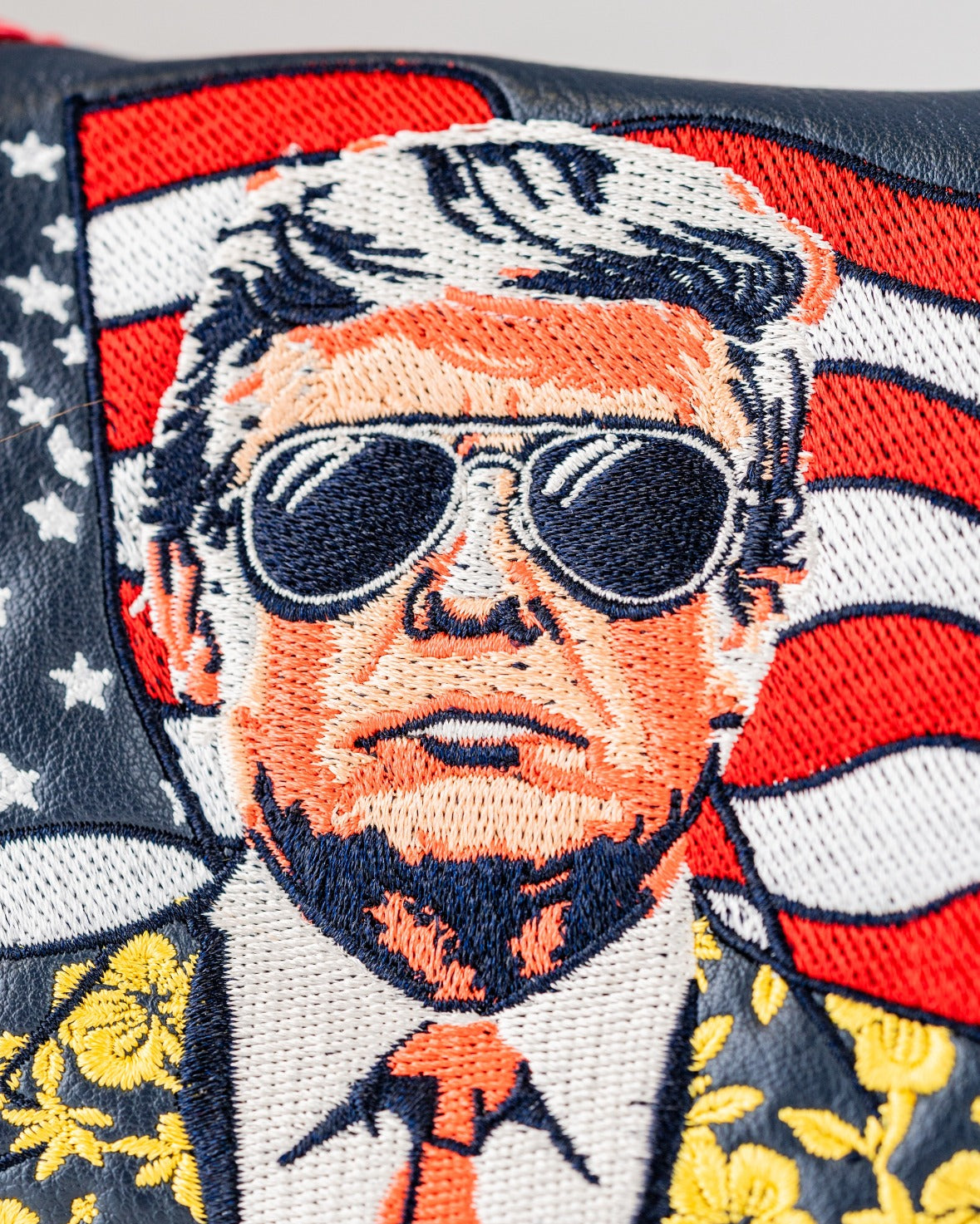 Bold mallet putter cover featuring an embroidered design of a man in sunglasses against an American flag backdrop.