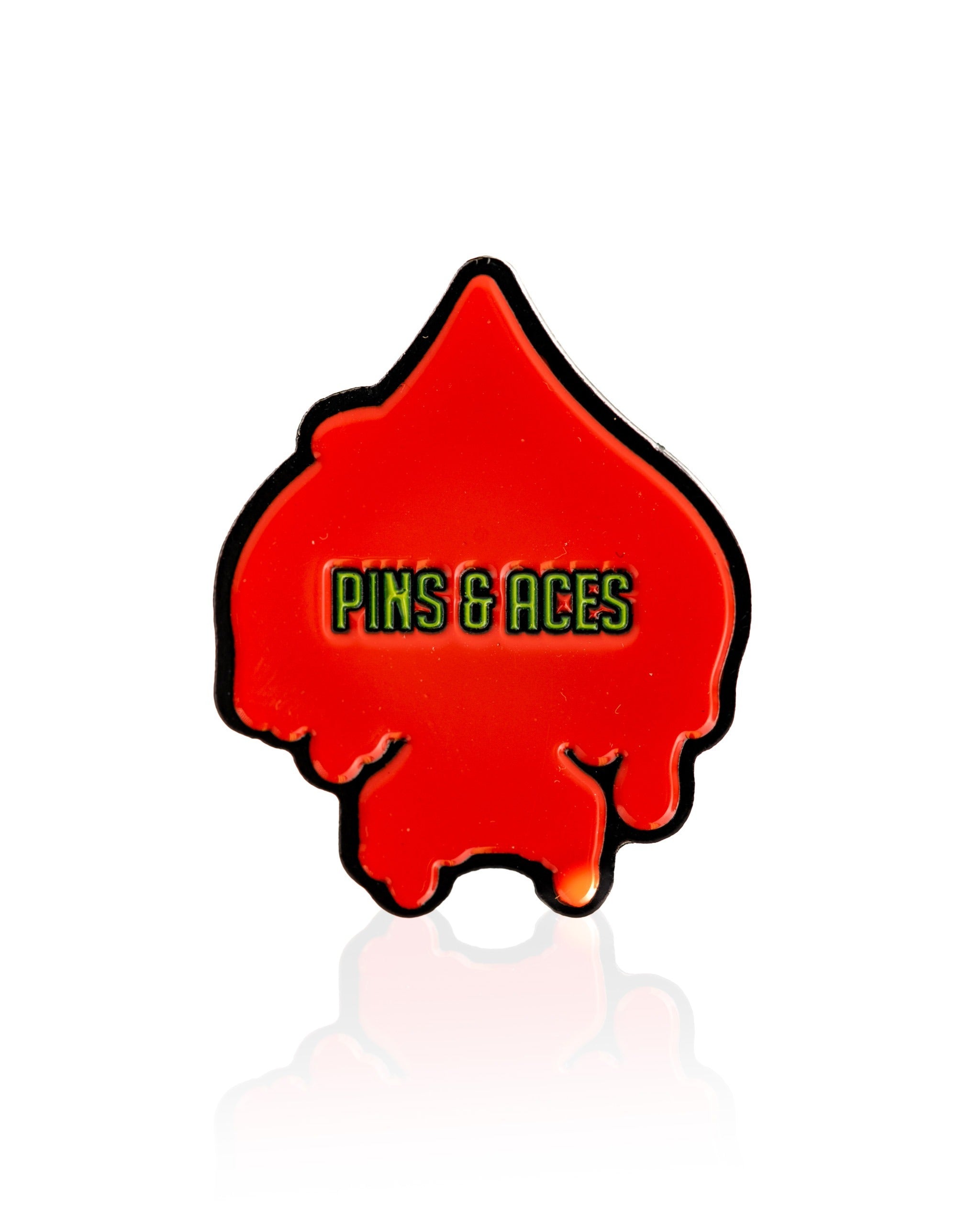 Bold red spade-shaped ball marker with dripping design and "Pins & Aces" logo, perfect for stylish golfers.