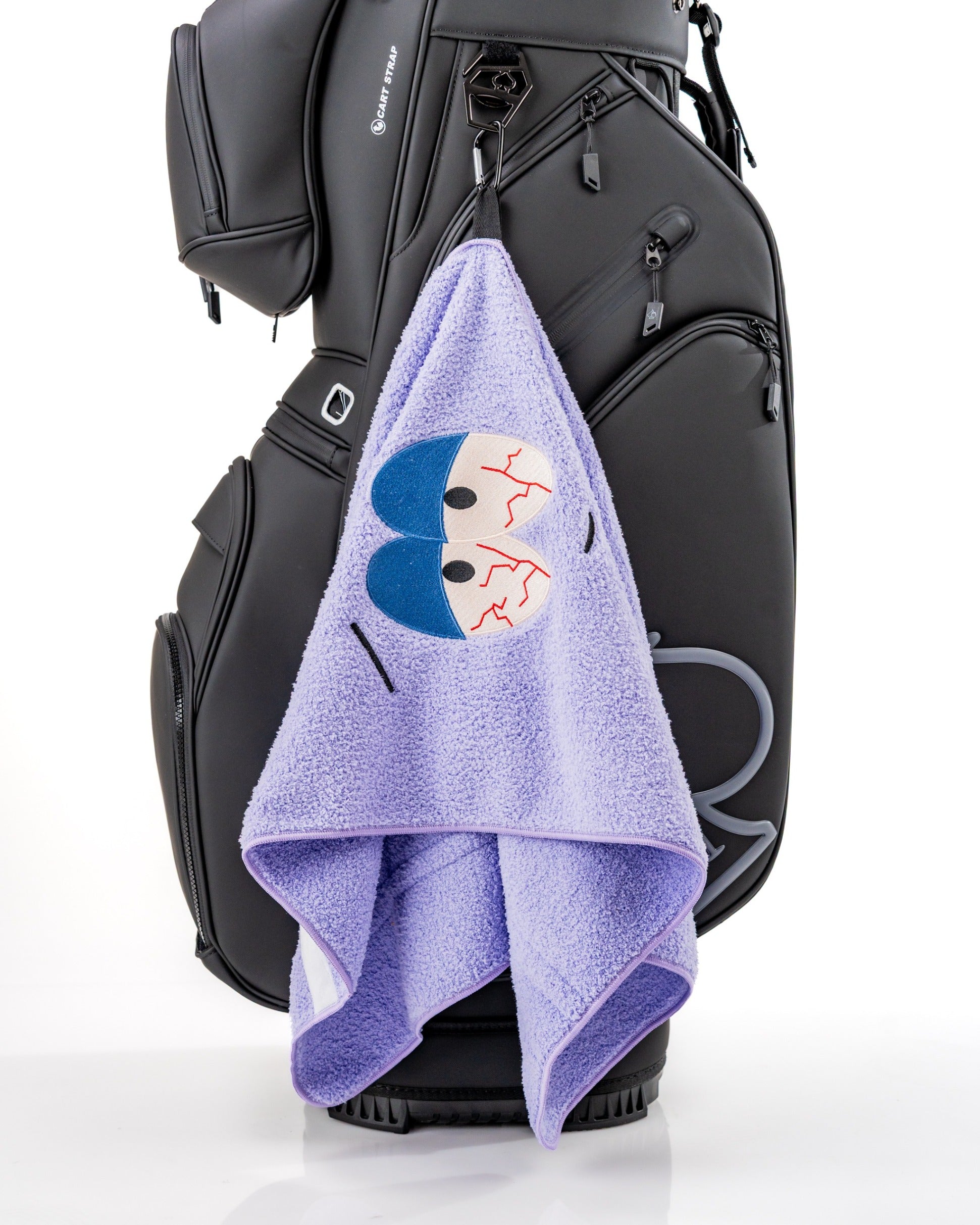 Purple towel featuring Towelie from South Park, hanging from a golf bag, ideal for adding fun to your golf game.