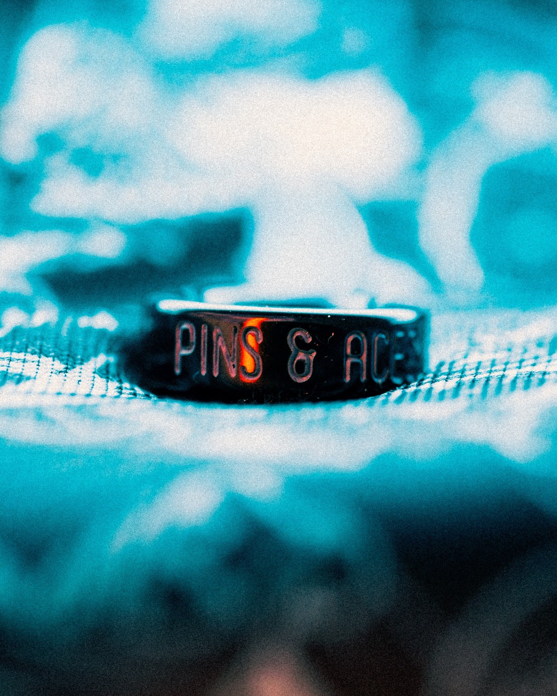 Mystery box featuring a sleek black ring with "Pins & Aces" engraved, perfect for bold golf enthusiasts.