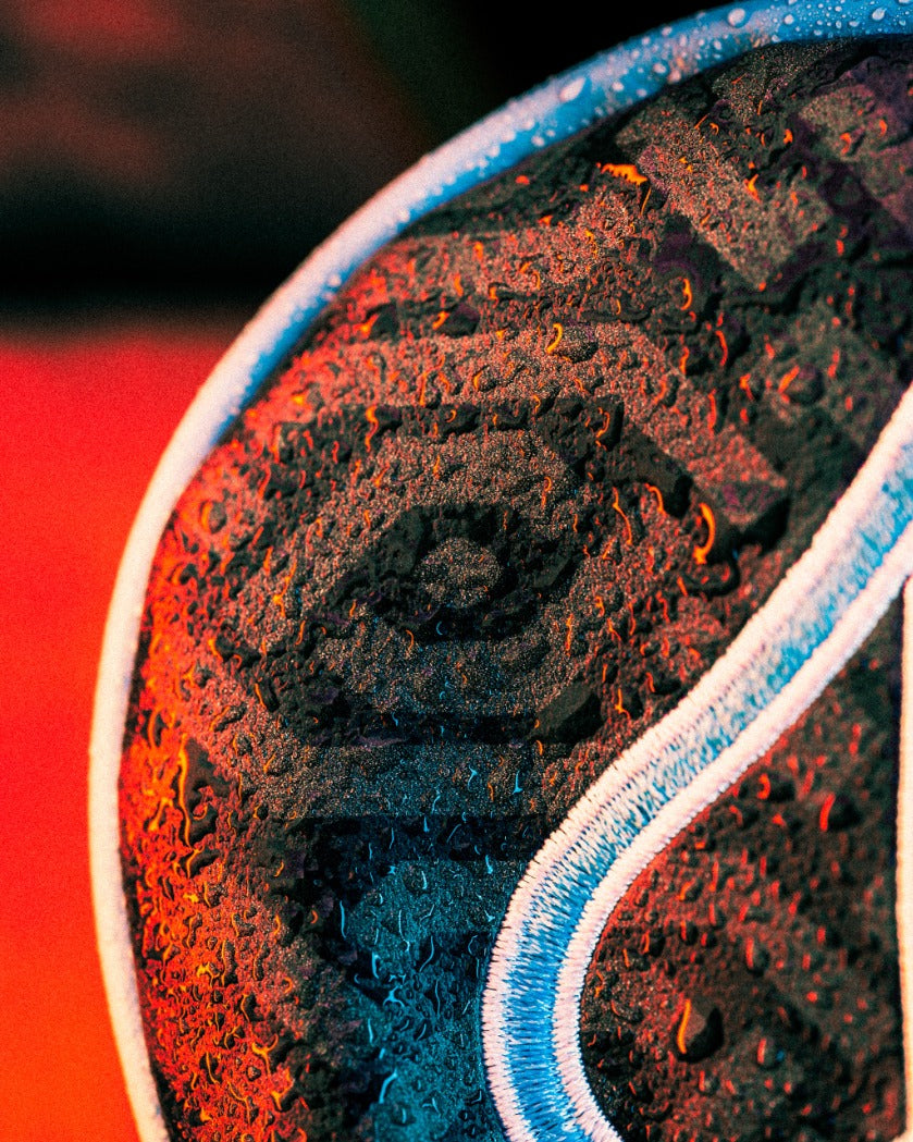 Close-up of a textured golf headcover featuring intricate patterns, showcasing vibrant colors and a sleek design.