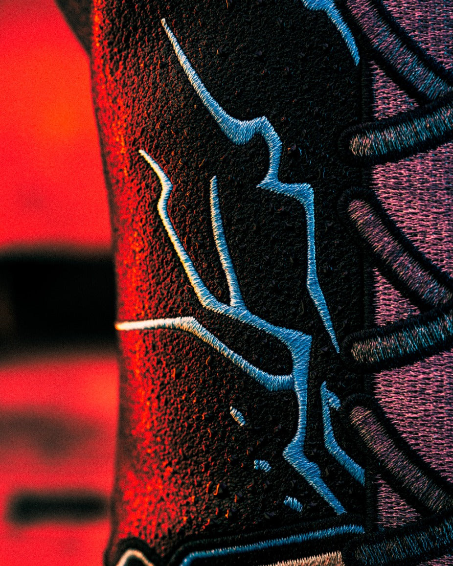 Close-up of a textured design featuring bold blue and black patterns, hinting at the mystery box contents for Black Friday 2025.