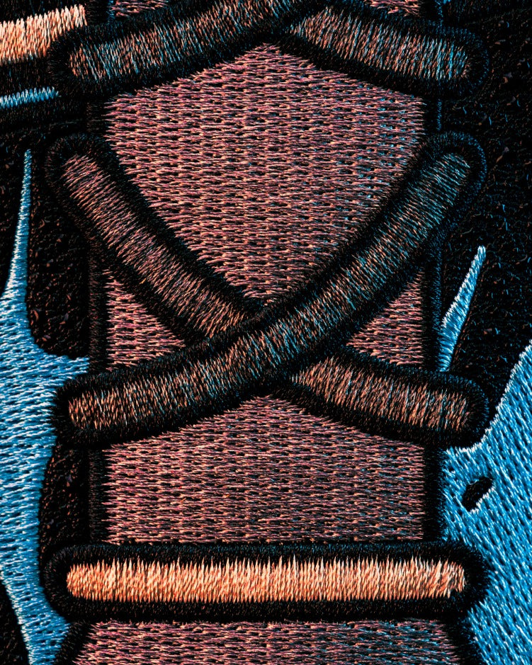 Close-up of intricate embroidery showcasing bold colors and patterns, highlighting the unique design of a mystery box.