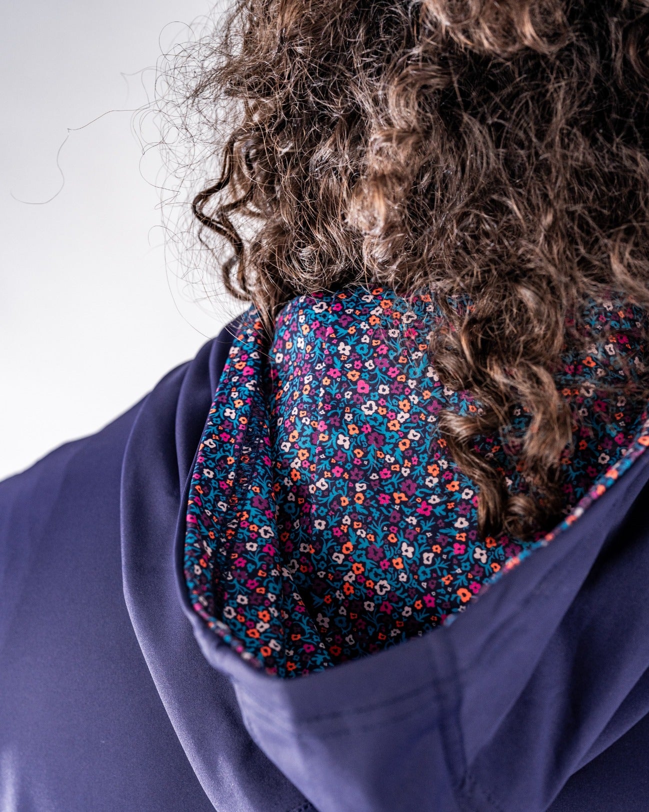 Lavender golf hoodie featuring a vibrant floral pattern on the interior lining, designed for stylish performance on the course.