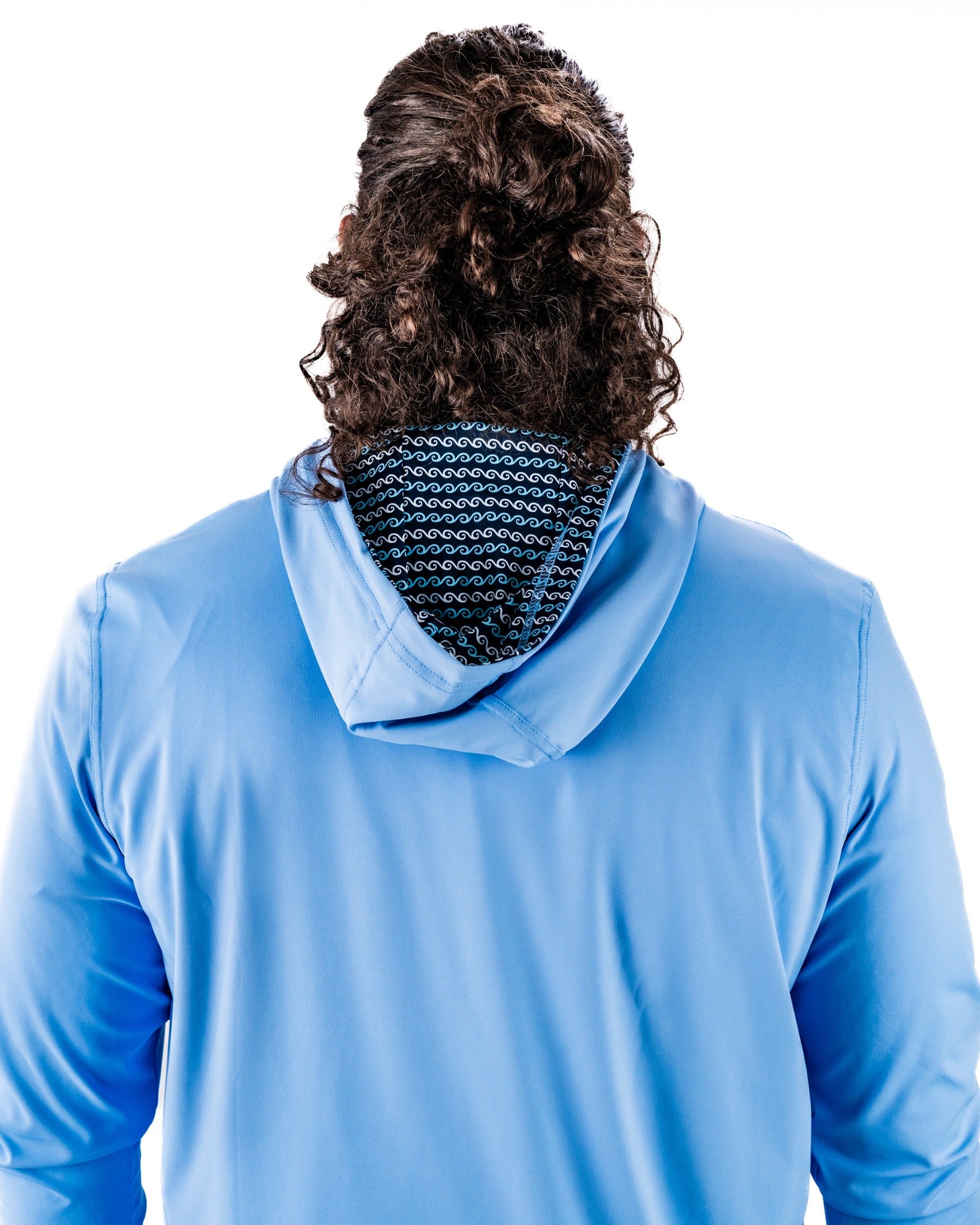Back view of a Performance Golf Hoodie in light blue, featuring a patterned interior lining and a relaxed fit.