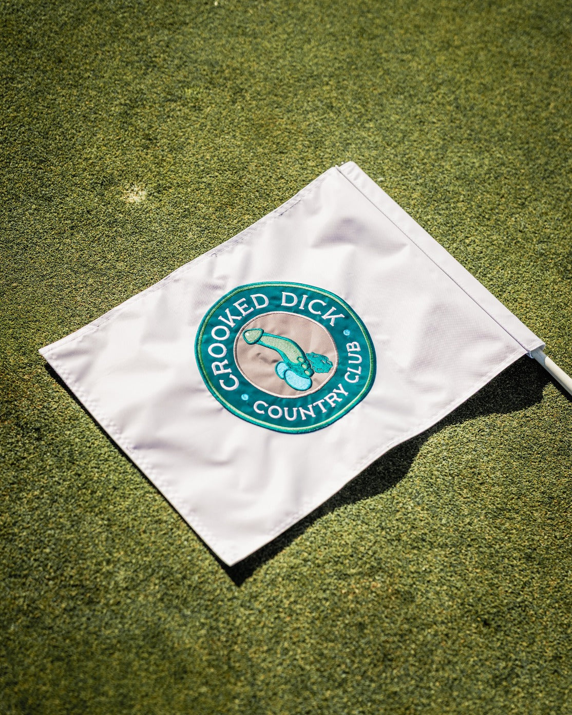 Golf flag featuring the Crooked Dick Club logo, designed for golfers who appreciate unique and bold accessories.