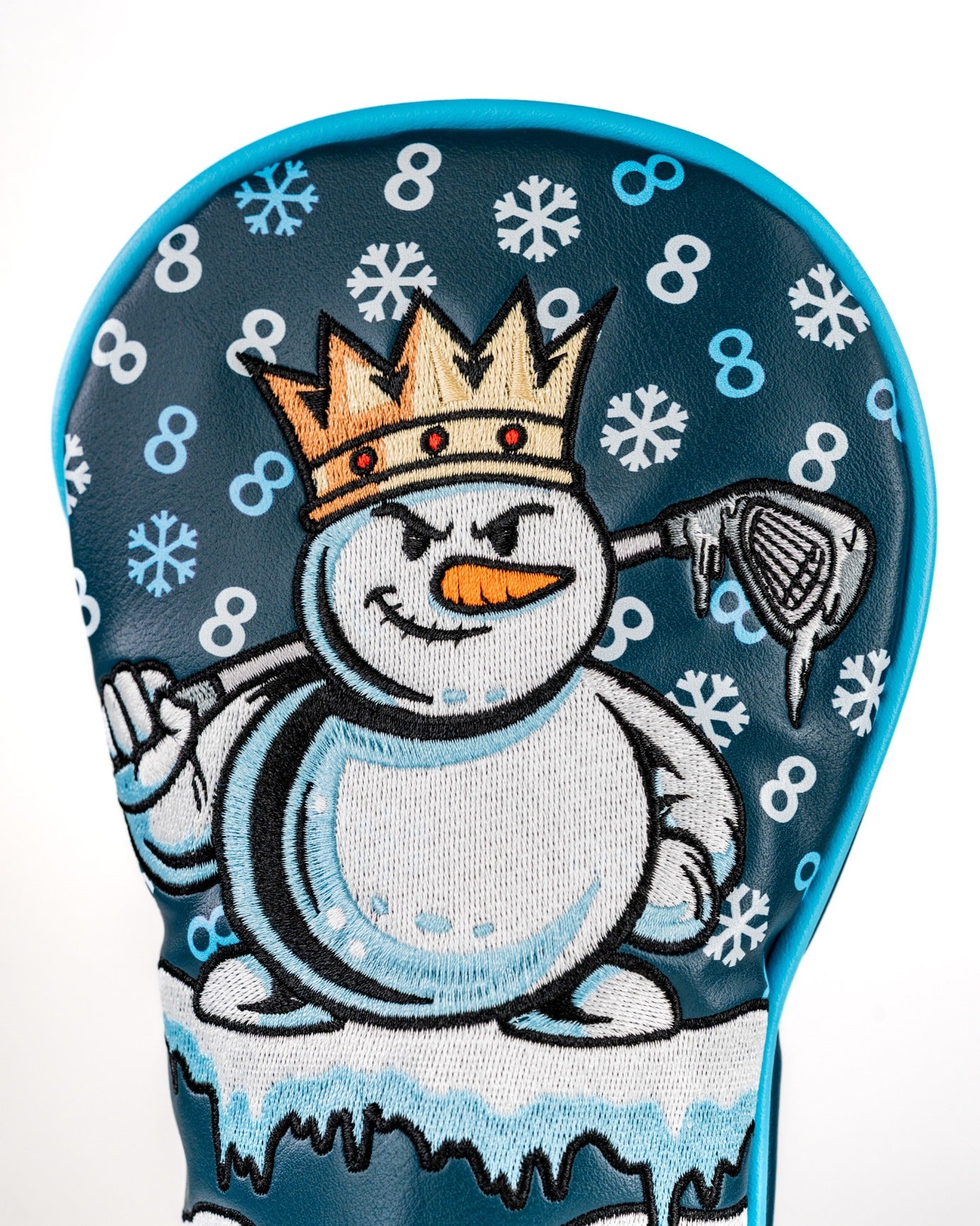Snowman fairway cover featuring a playful design with a crowned snowman holding a golf club against a snowy background.
