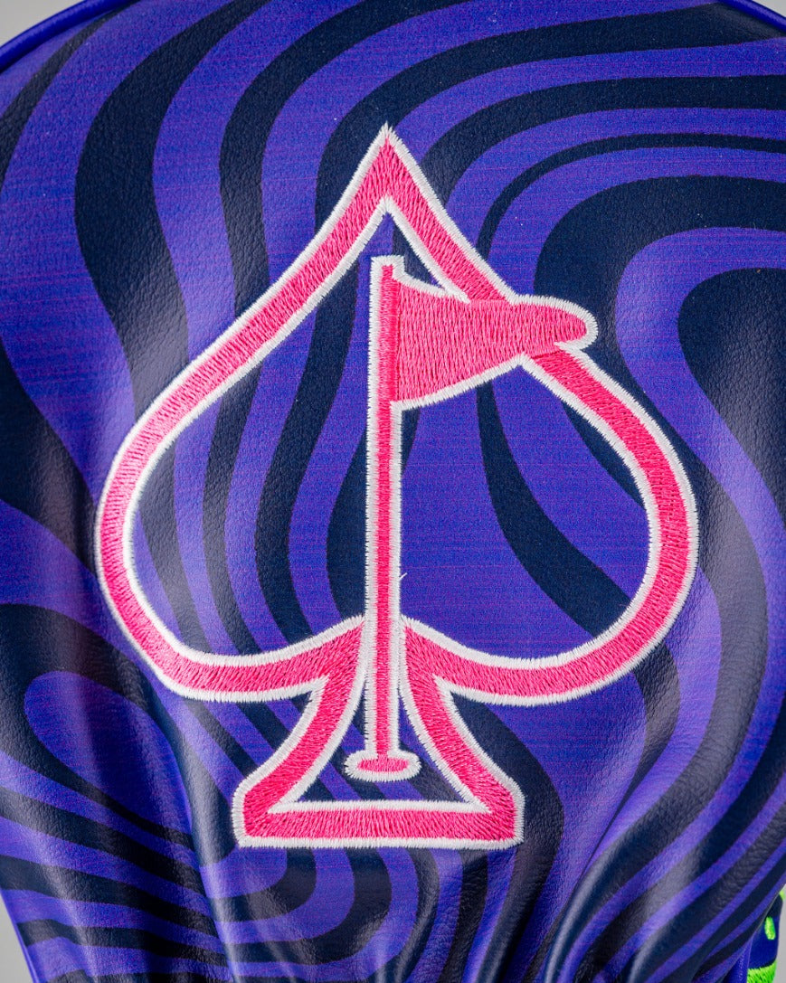 Bold alien-themed driver cover featuring a vibrant purple and blue swirl design with a pink spade logo.