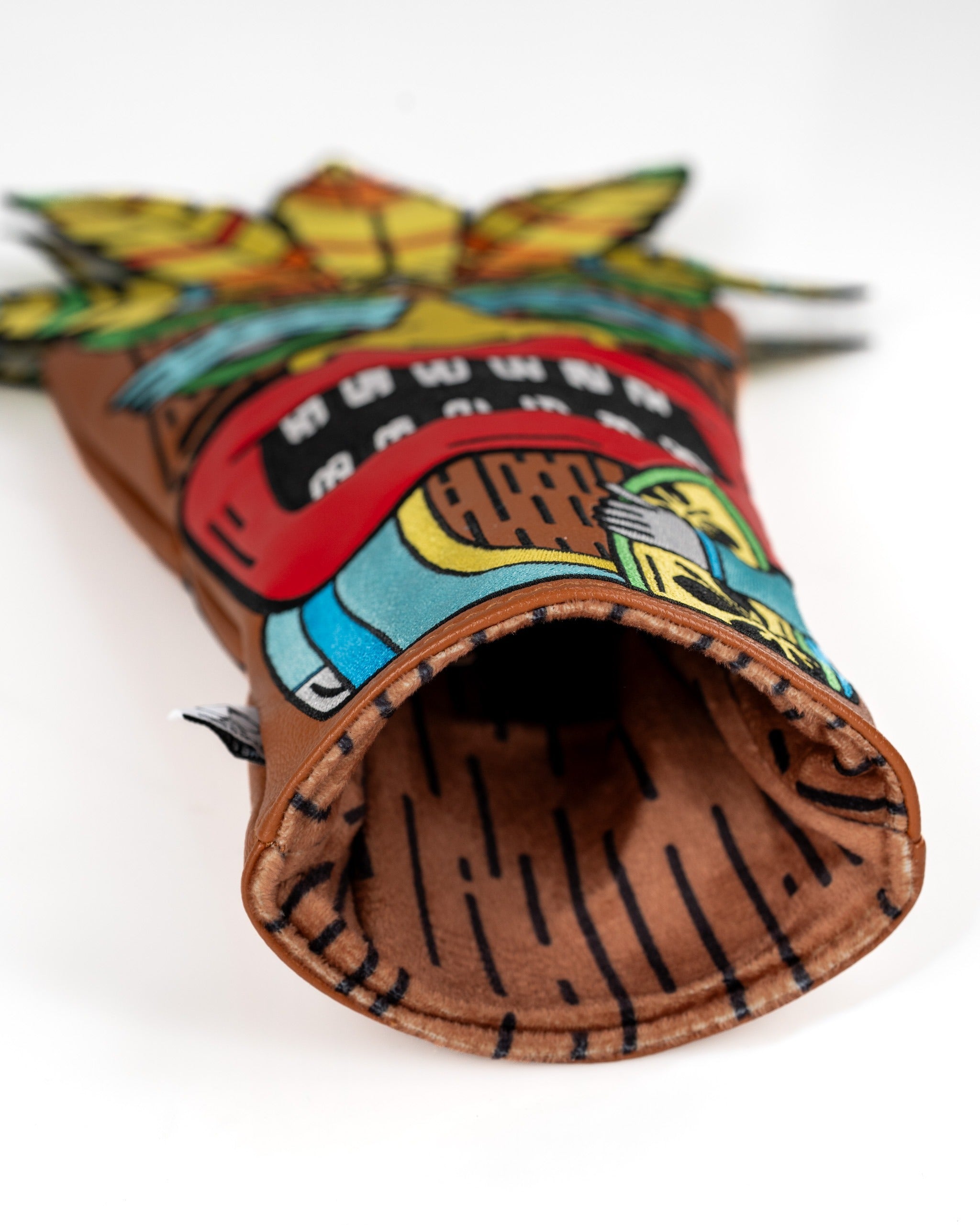 Colorful Tiki driver cover featuring a vibrant design with a pineapple and tribal patterns, perfect for unique golf style.