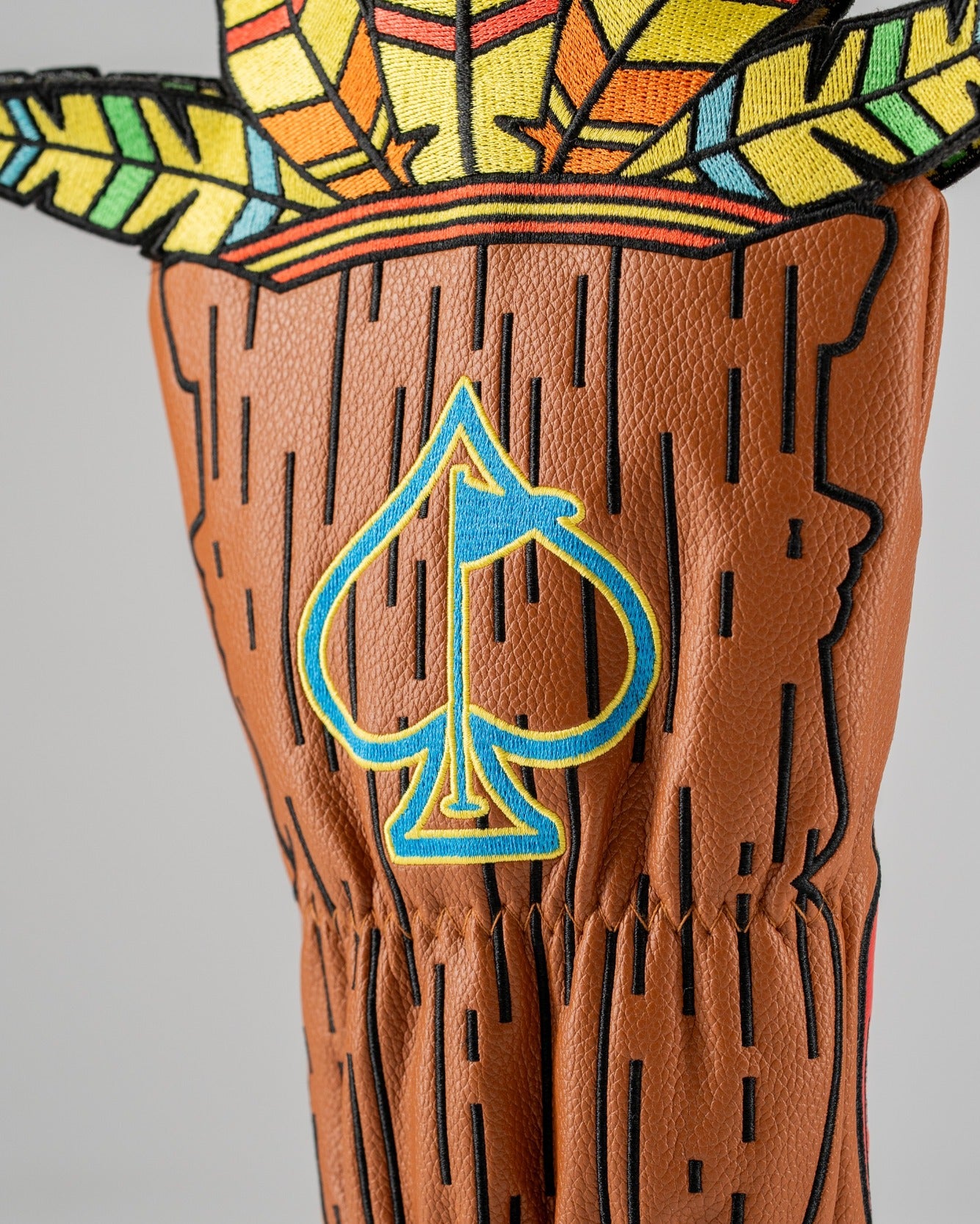 Bold Tiki driver cover featuring vibrant colors and a unique design with feather accents and a blue spade logo.