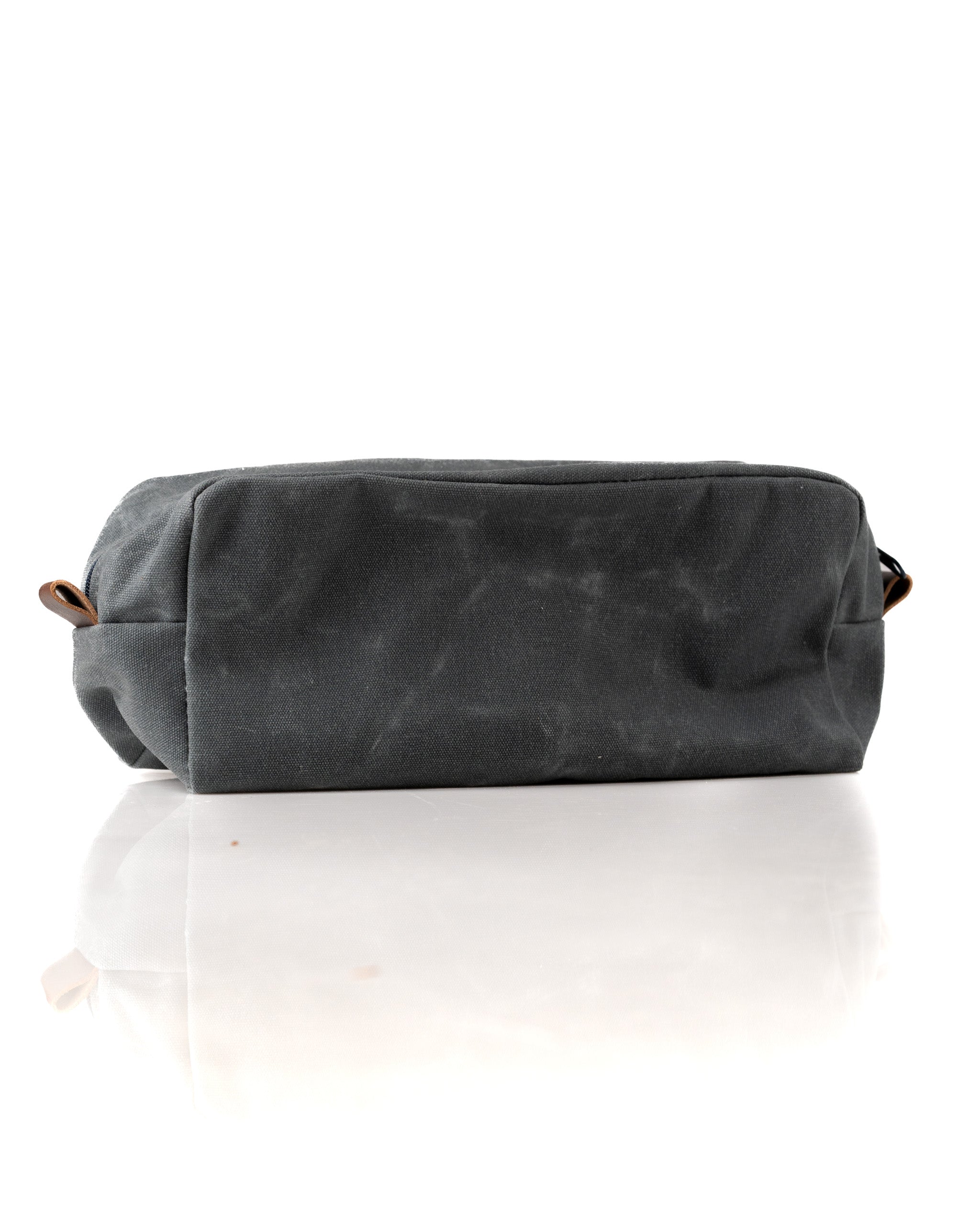 Stylish gray toiletry bag with a sleek design and leather accents, perfect for organizing travel essentials.