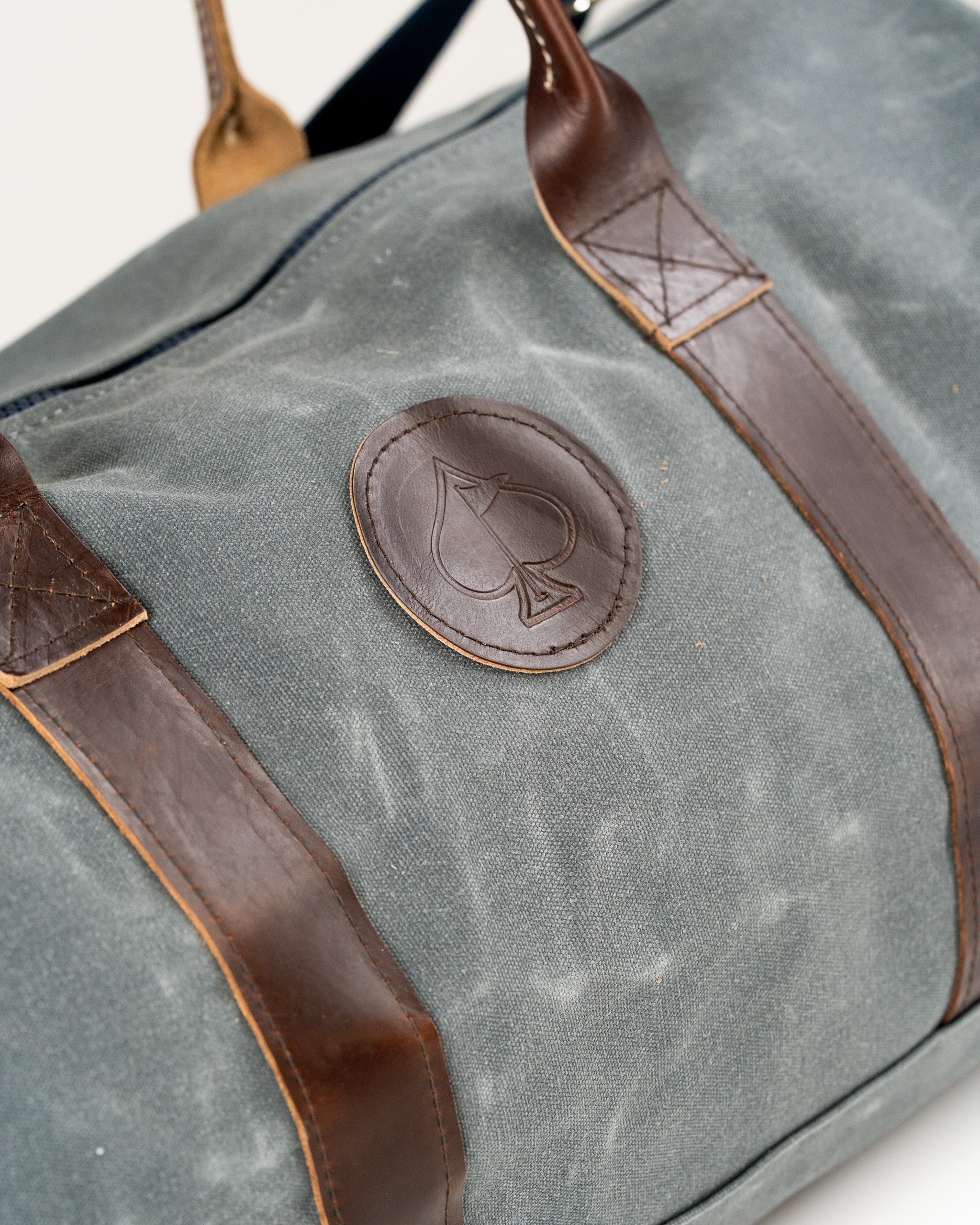 Stylish duffel bag featuring a leather logo and sturdy handles, perfect for travel or gym use. Ideal for bold golfers.