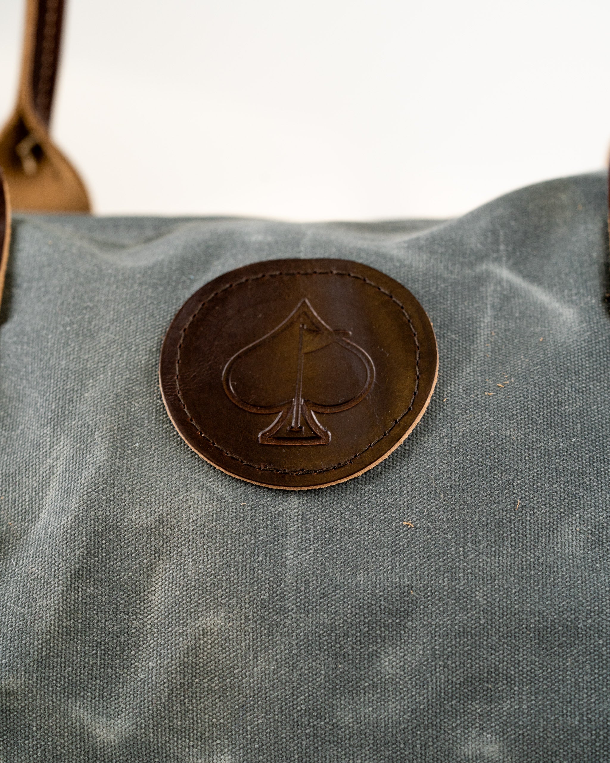 Stylish Black Friday duffel bag featuring a leather spade logo, perfect for golfers seeking a bold accessory.