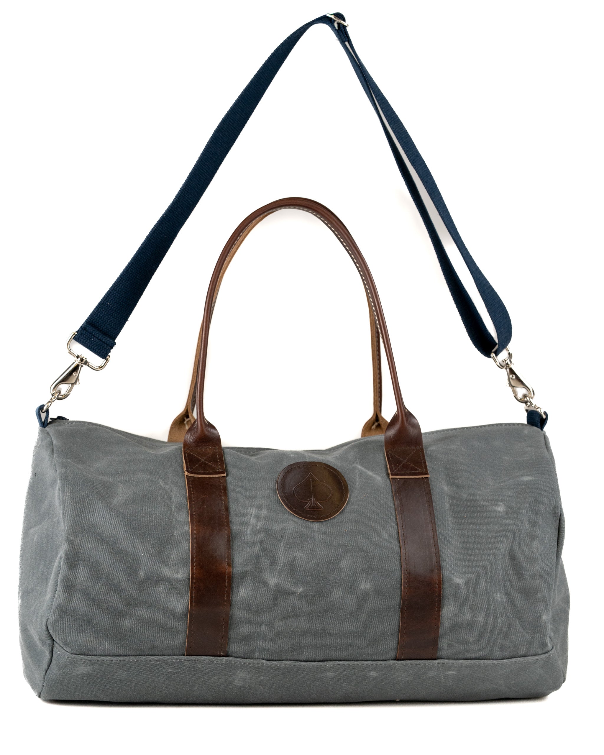 Stylish duffel bag featuring a gray canvas body and brown leather accents, perfect for travel or gym use.