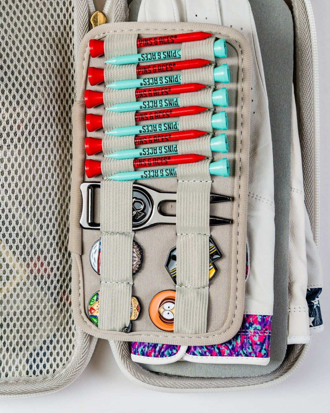Gray glove and accessory caddie featuring organized golf tees, a divot tool, and space for gloves and pins.