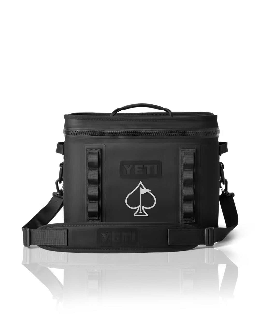 Durable Yeti Hopper Flip 18 cooler in black with a spade logo, featuring a sturdy handle and adjustable shoulder strap.