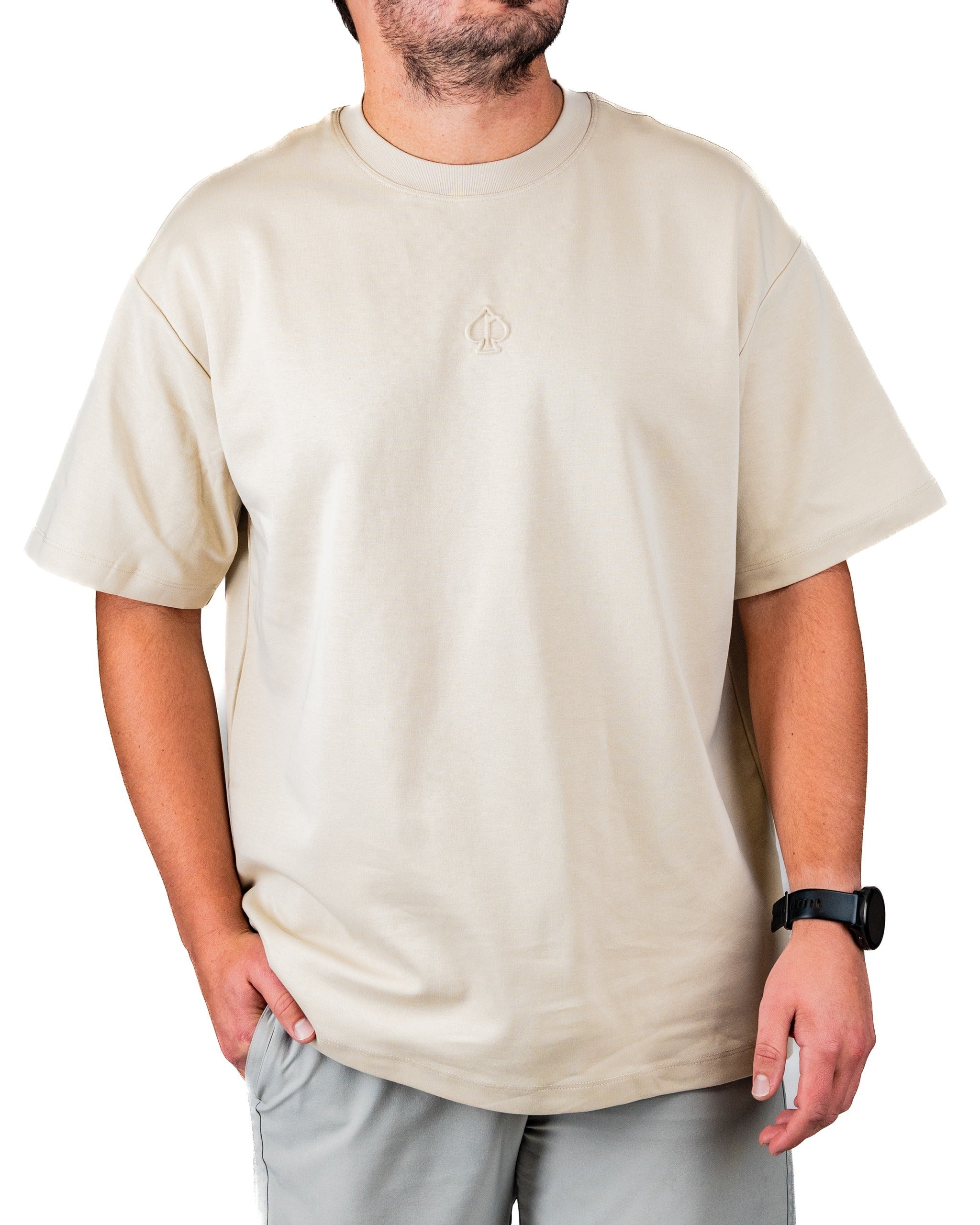 Cream embossed spade tee shirt featuring a subtle logo, designed for a stylish and comfortable golf experience.