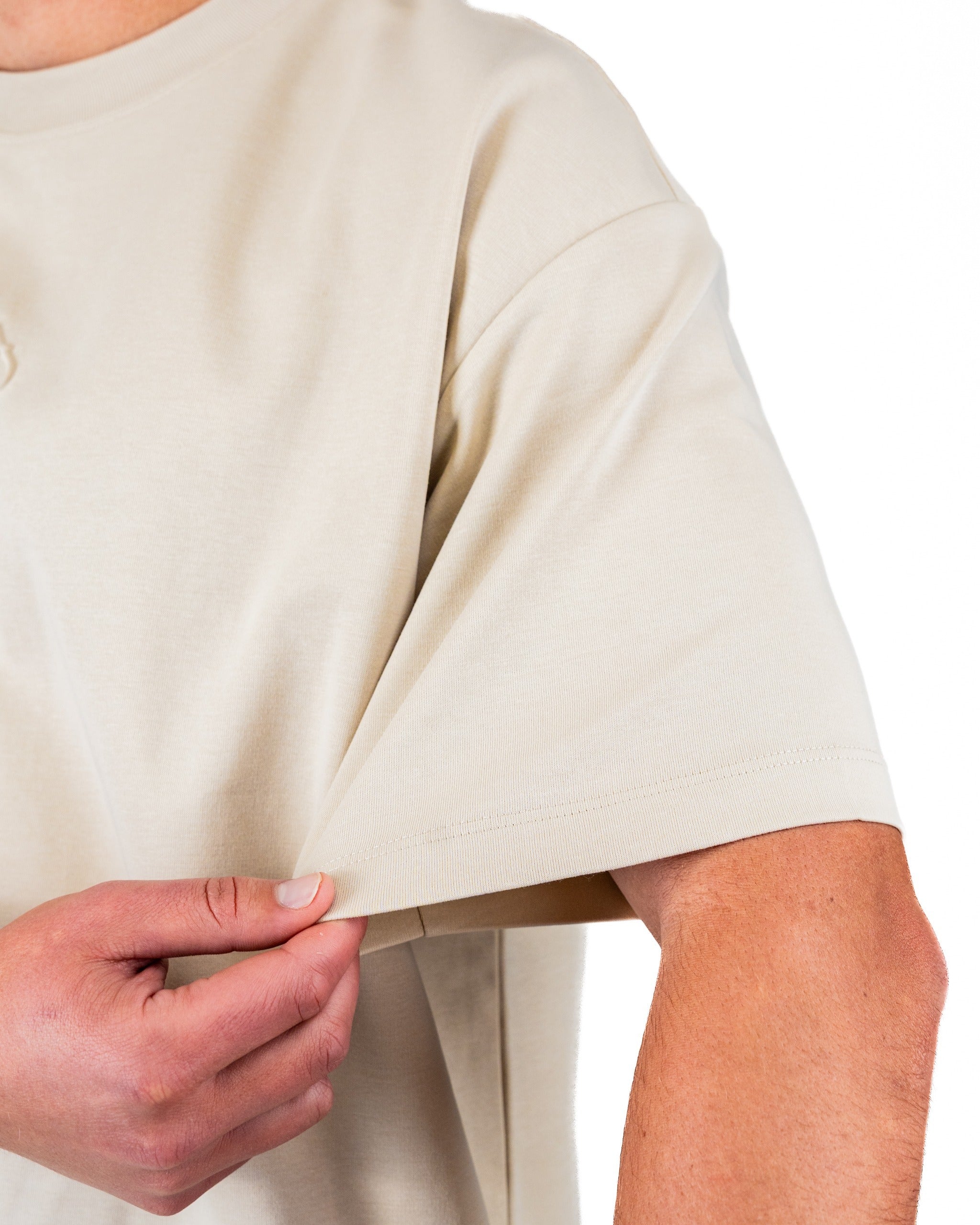 Cream embossed spade tee shirt featuring a relaxed fit and soft fabric, ideal for stylish comfort on the golf course.