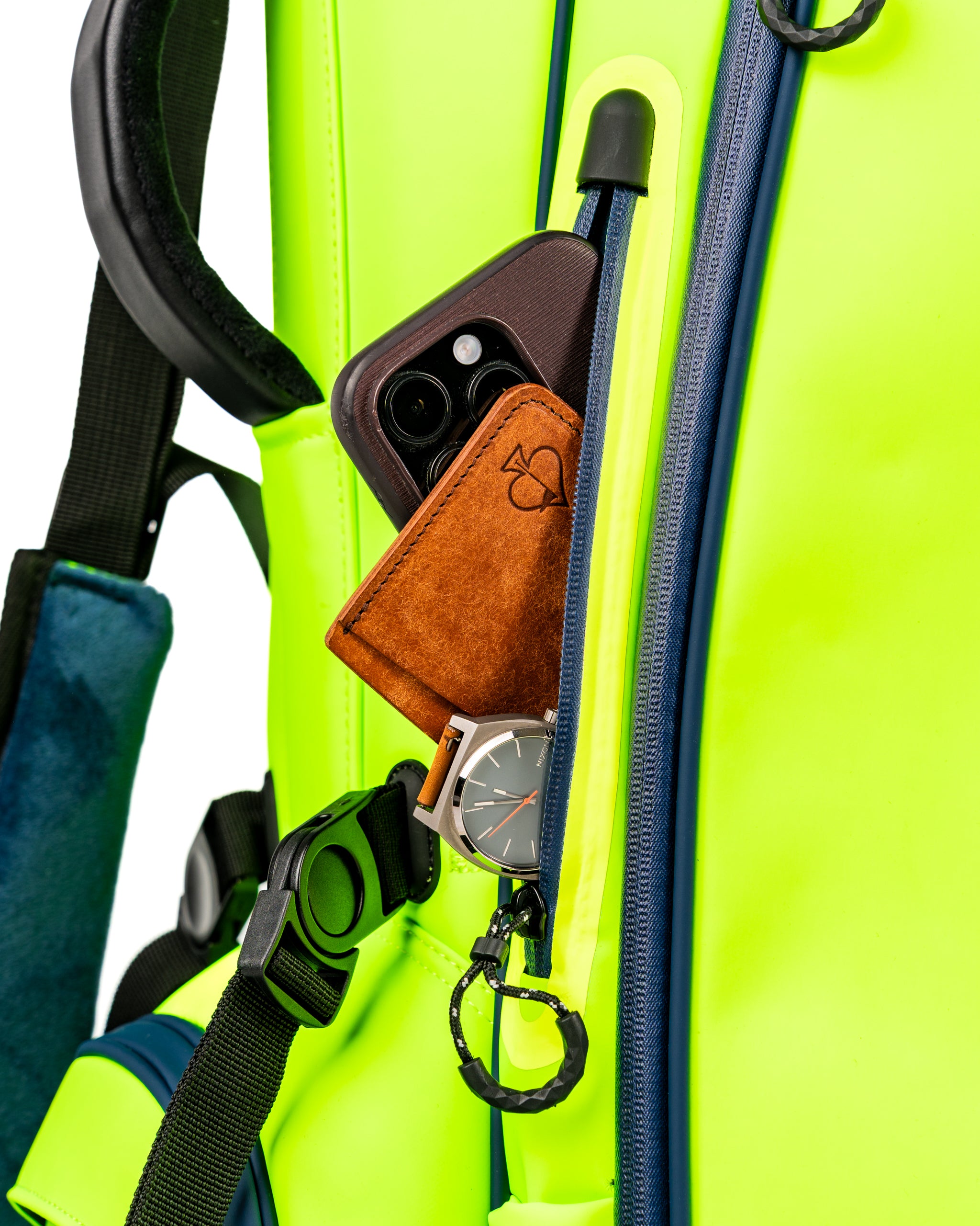 Close-up of the Player Preferred Golf Bag in Electric Tide, featuring a phone, wallet, and watch in the front pocket.