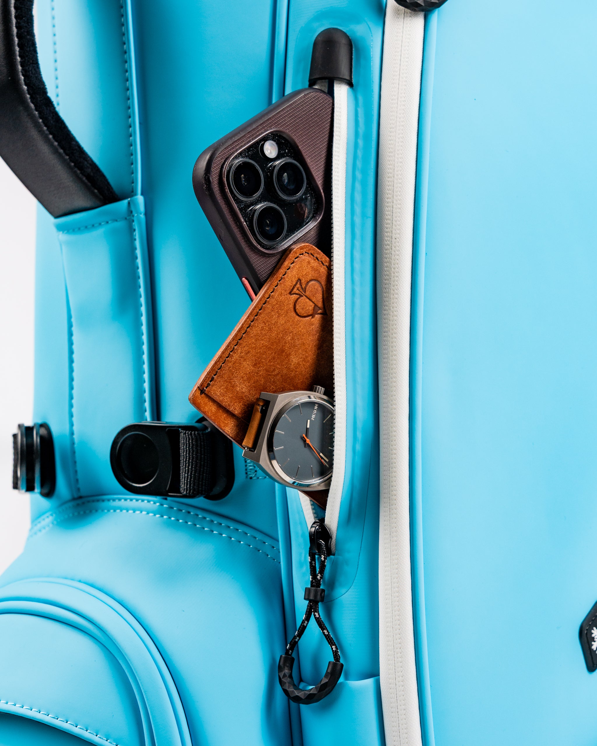 Close-up of the Glacier Player Preferred Golf Bag featuring a phone, wallet, and watch in the side pocket.