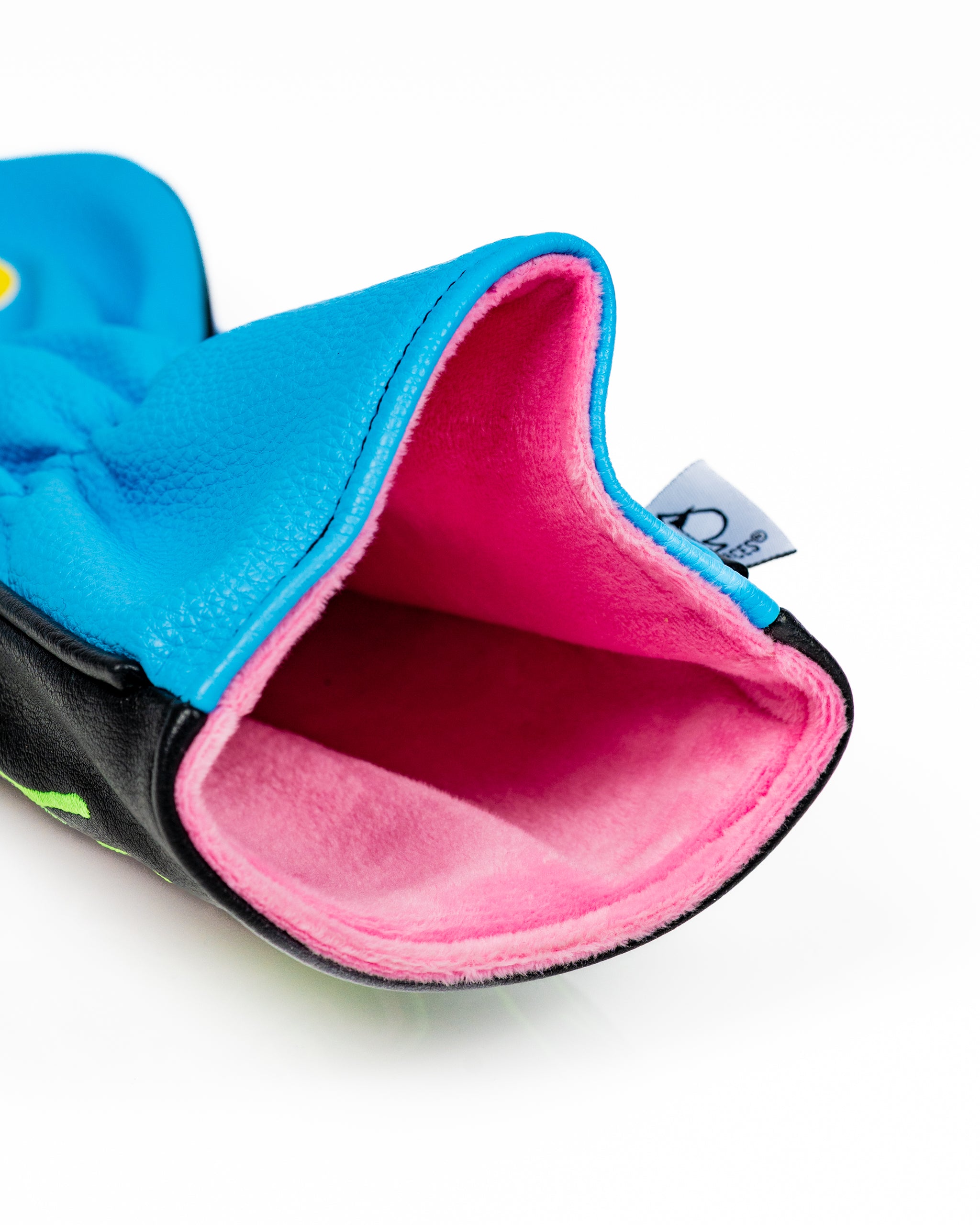 Brightly colored driver cover featuring a blue exterior and pink lining, designed for golfers seeking a standout accessory.