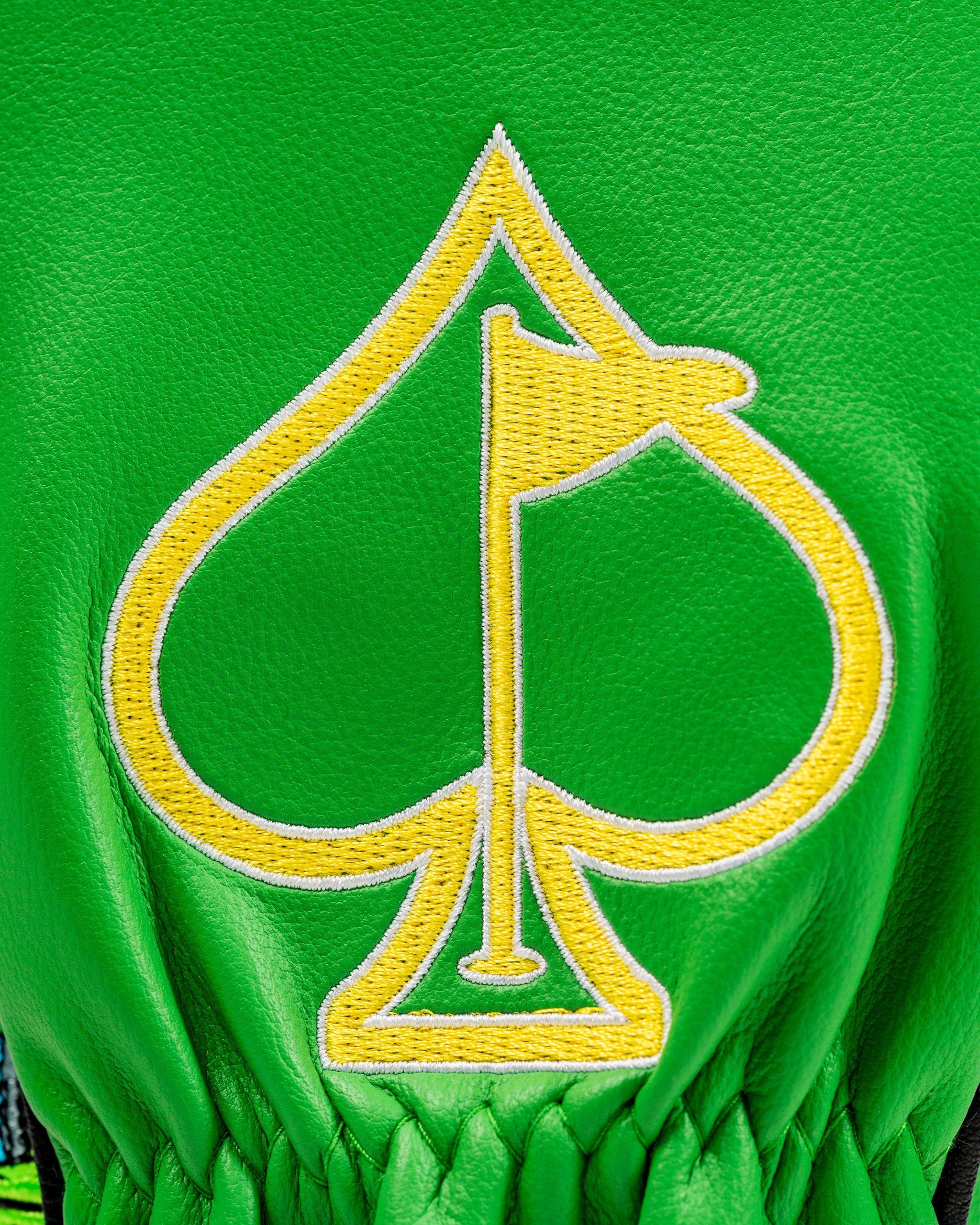Bright green fairway cover featuring a bold yellow spade logo with a flag, designed for golfers seeking unique style.