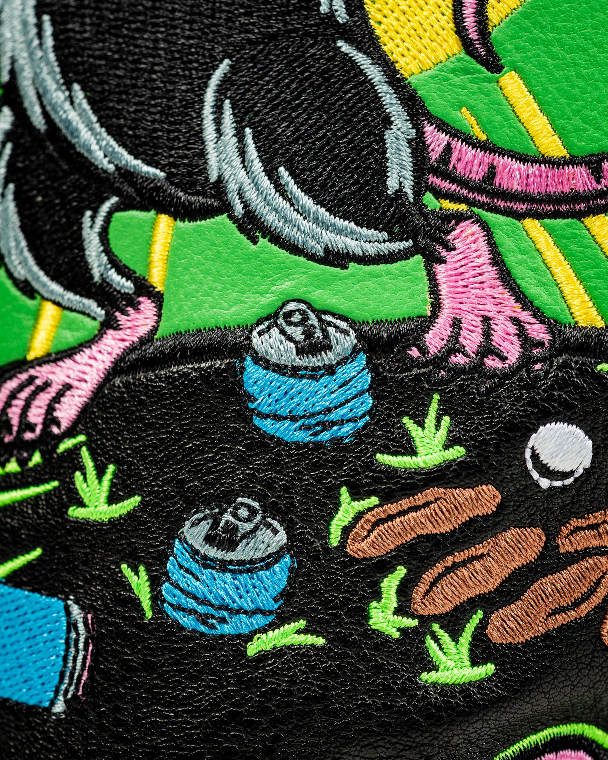 Colorful embroidered design featuring a playful rat and golf elements on a fairway cover, perfect for unique golf style.