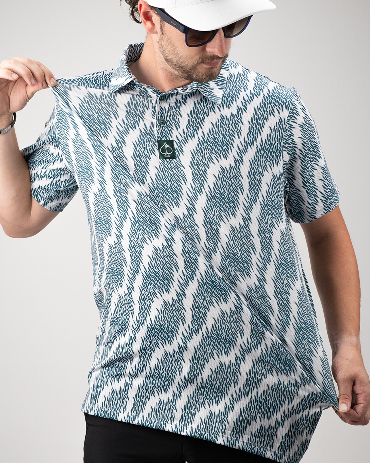 Model showcasing the Stripish golf polo shirt with a bold, abstract pattern in teal and white, perfect for stylish golfers.
