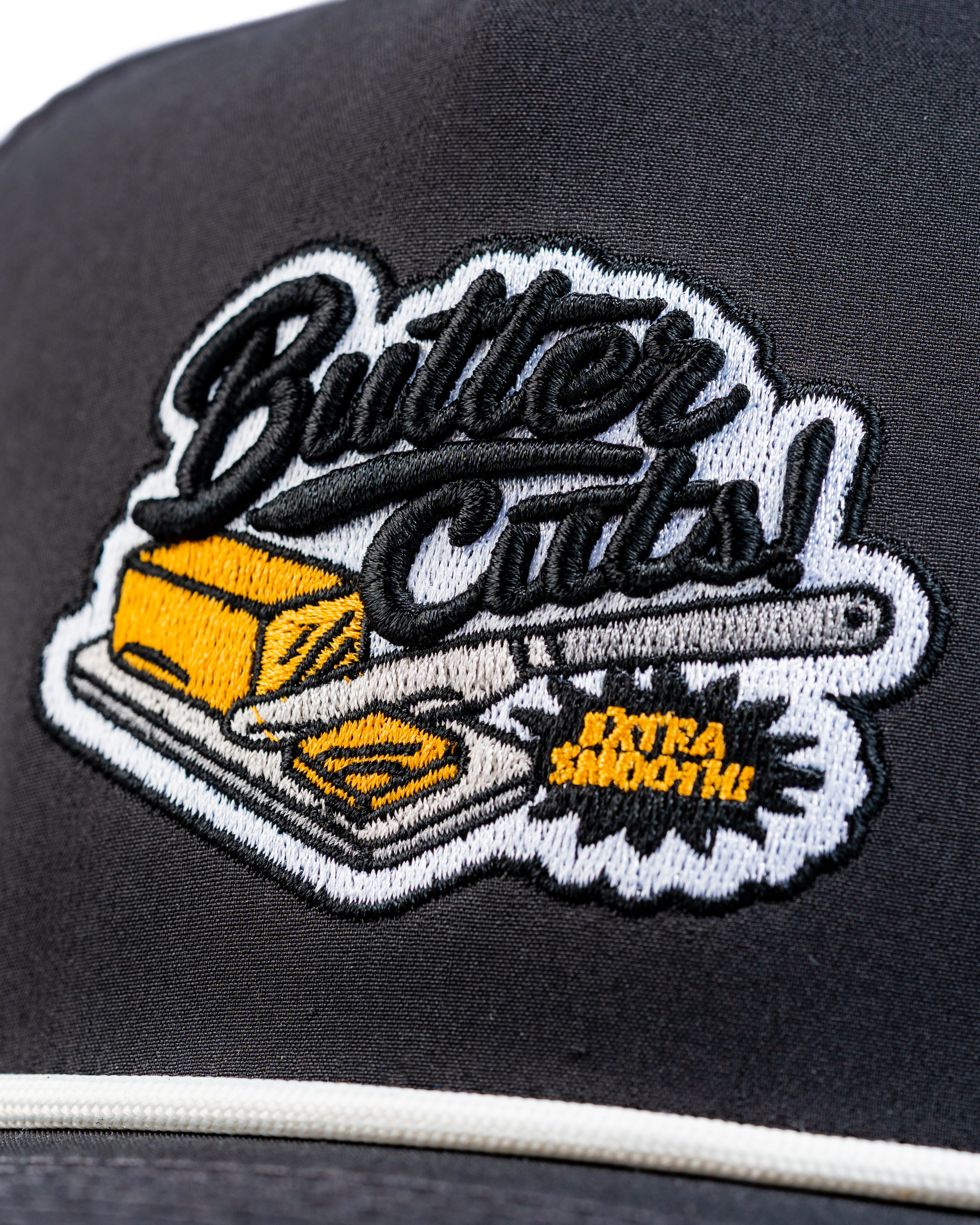 Perforated Rope Hat featuring a Butter Cuts logo with a butter stick and knife, designed for stylish golfers.