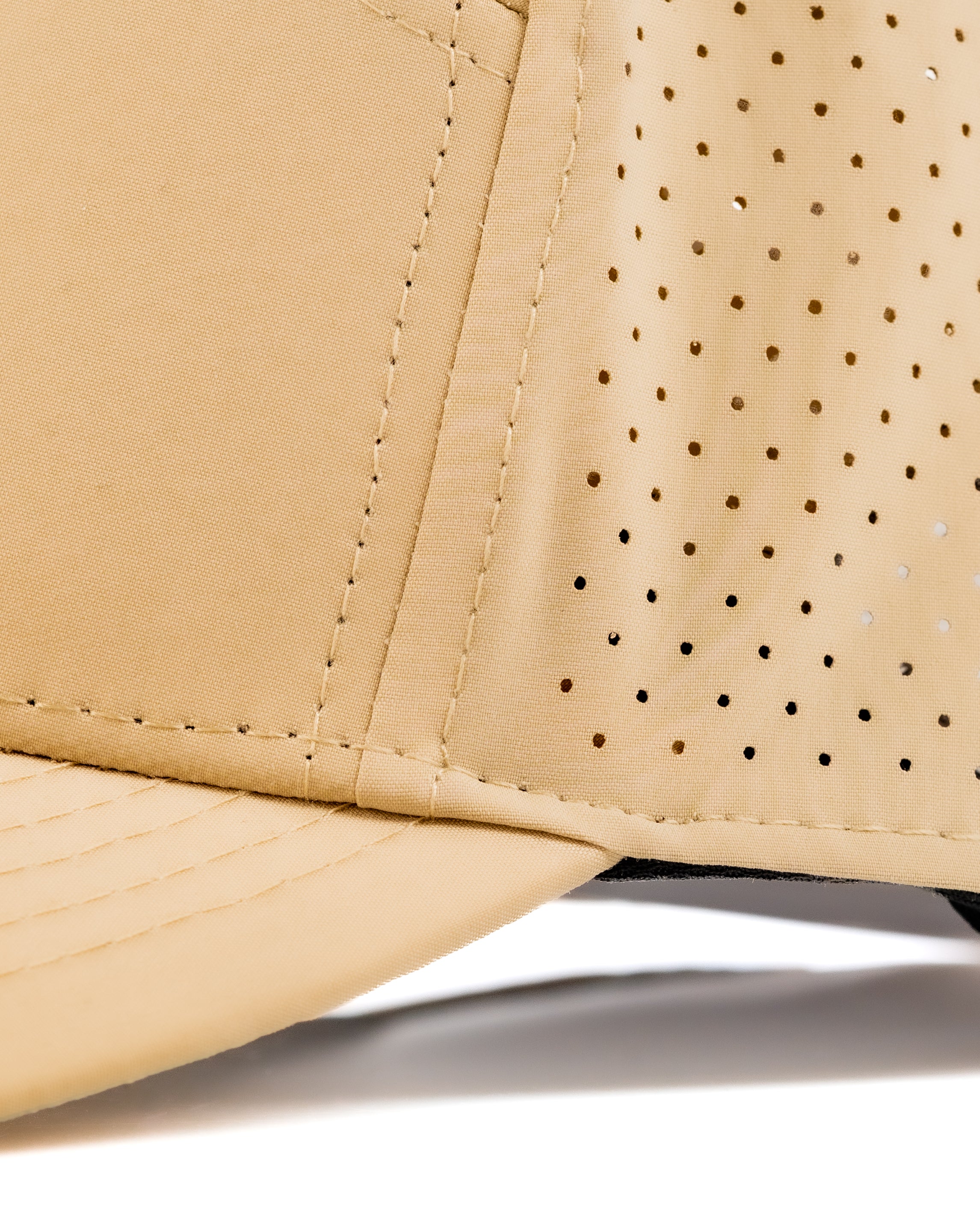 Close-up of the Tradesman Hat in Dry Fly color, showcasing its breathable perforated fabric and structured brim.