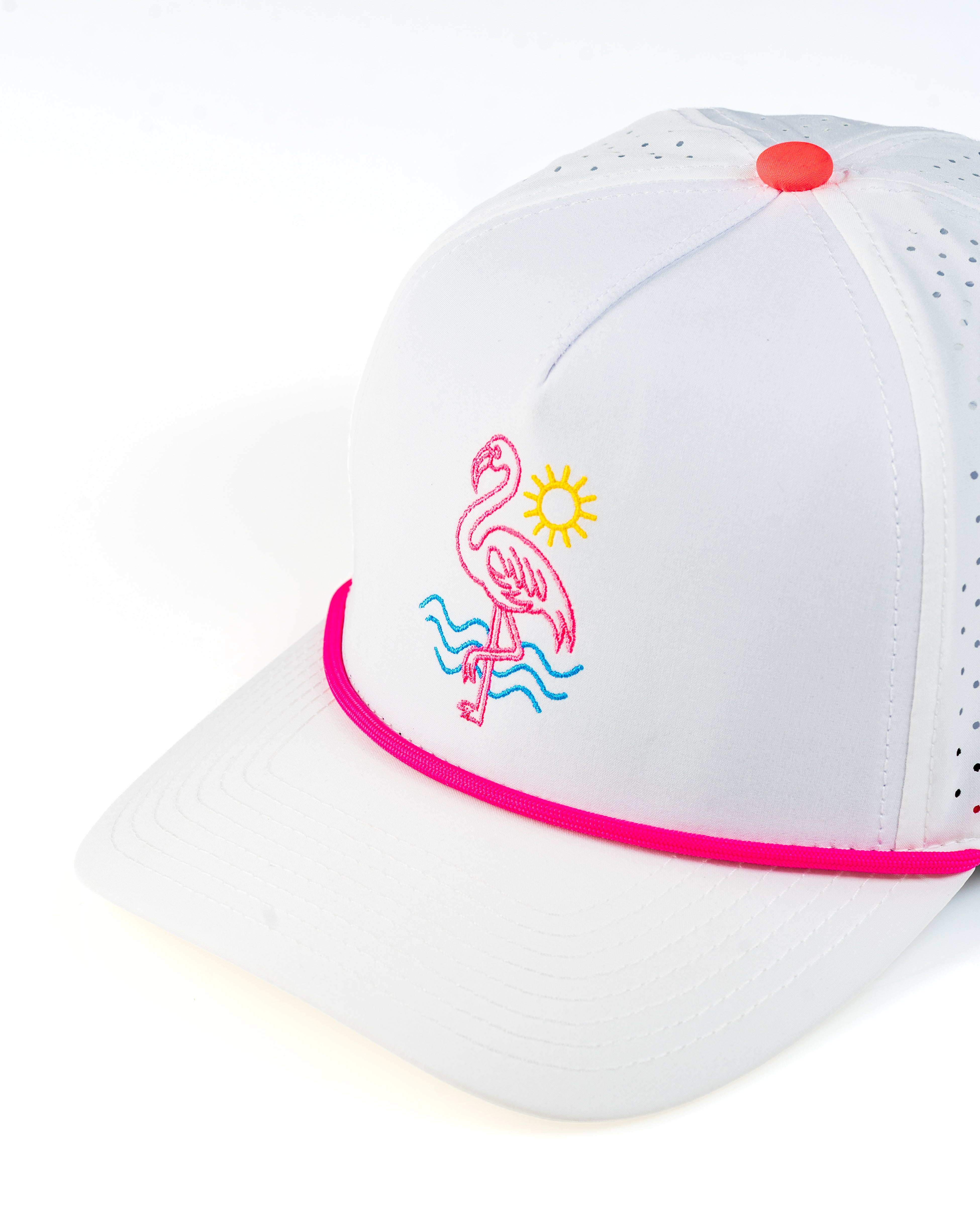 Perforated rope hat in white featuring a pink flamingo and sun design, perfect for stylish golfers.