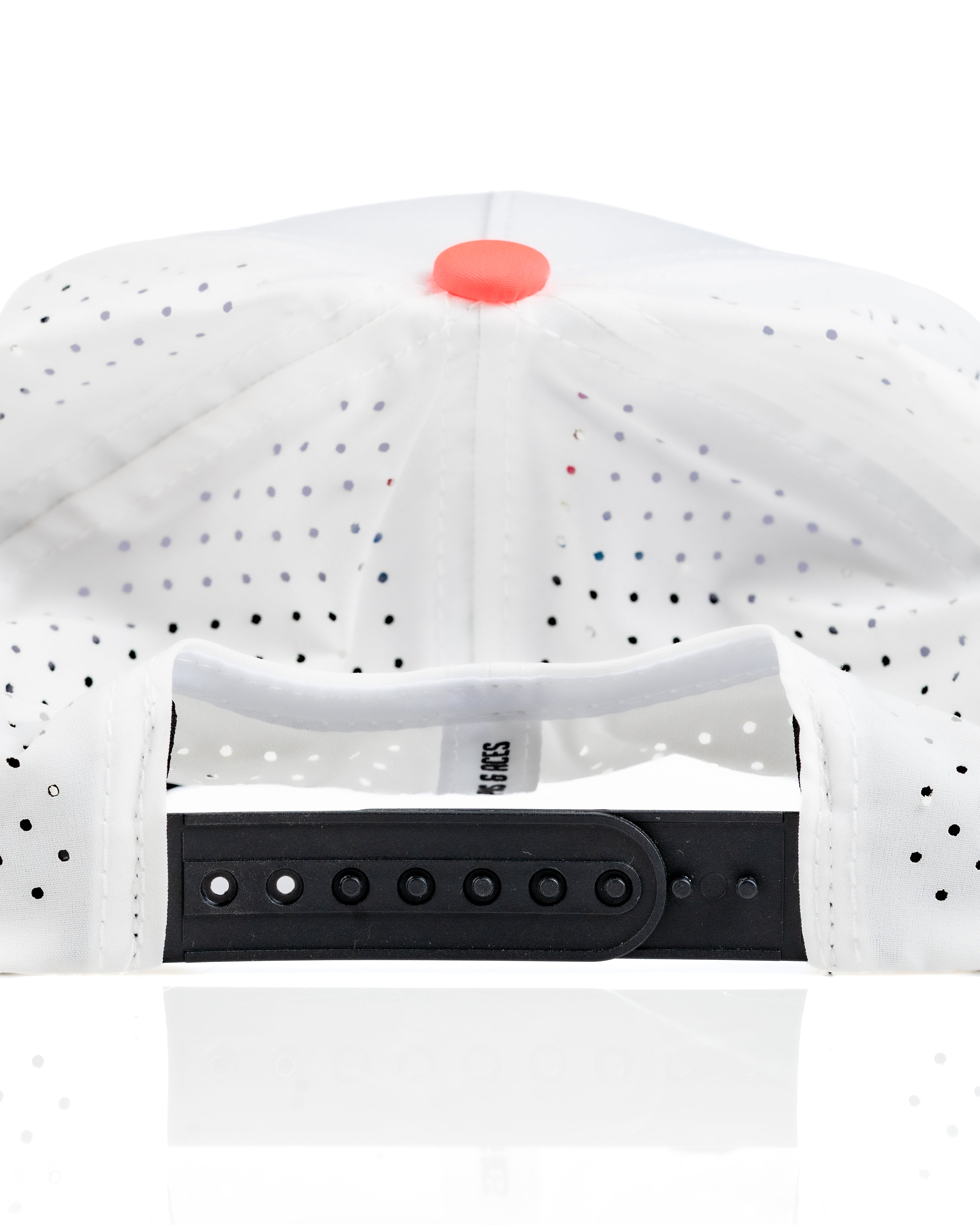 Perforated white rope hat with a flamingo design, featuring a black adjustable strap and colorful button on top.