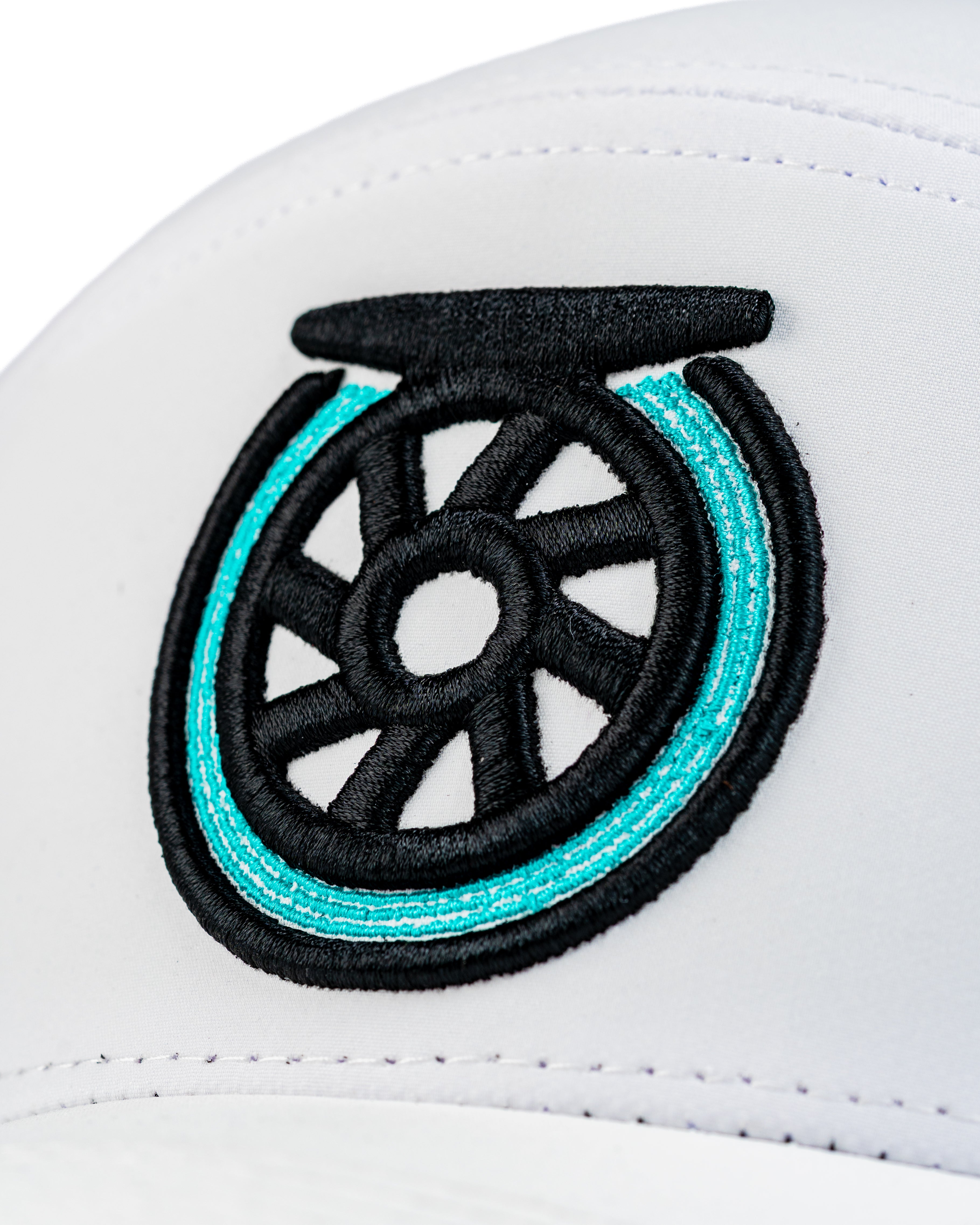 Close-up of the Tradesman Hat featuring a bold embroidered reel logo in black and turquoise on a white cap.