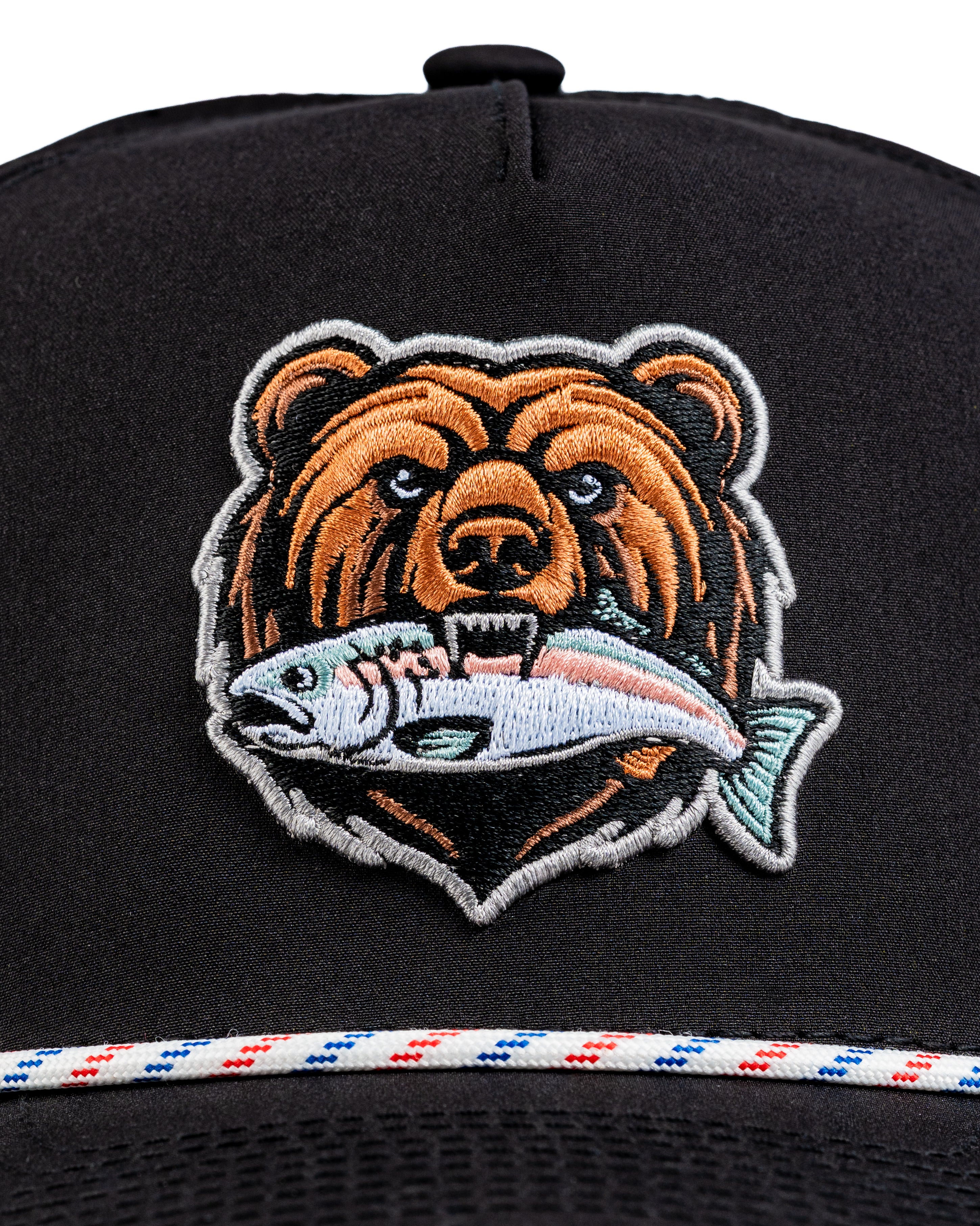 Bold black perforated rope hat featuring a detailed bear logo holding a fish, perfect for stylish golfers.