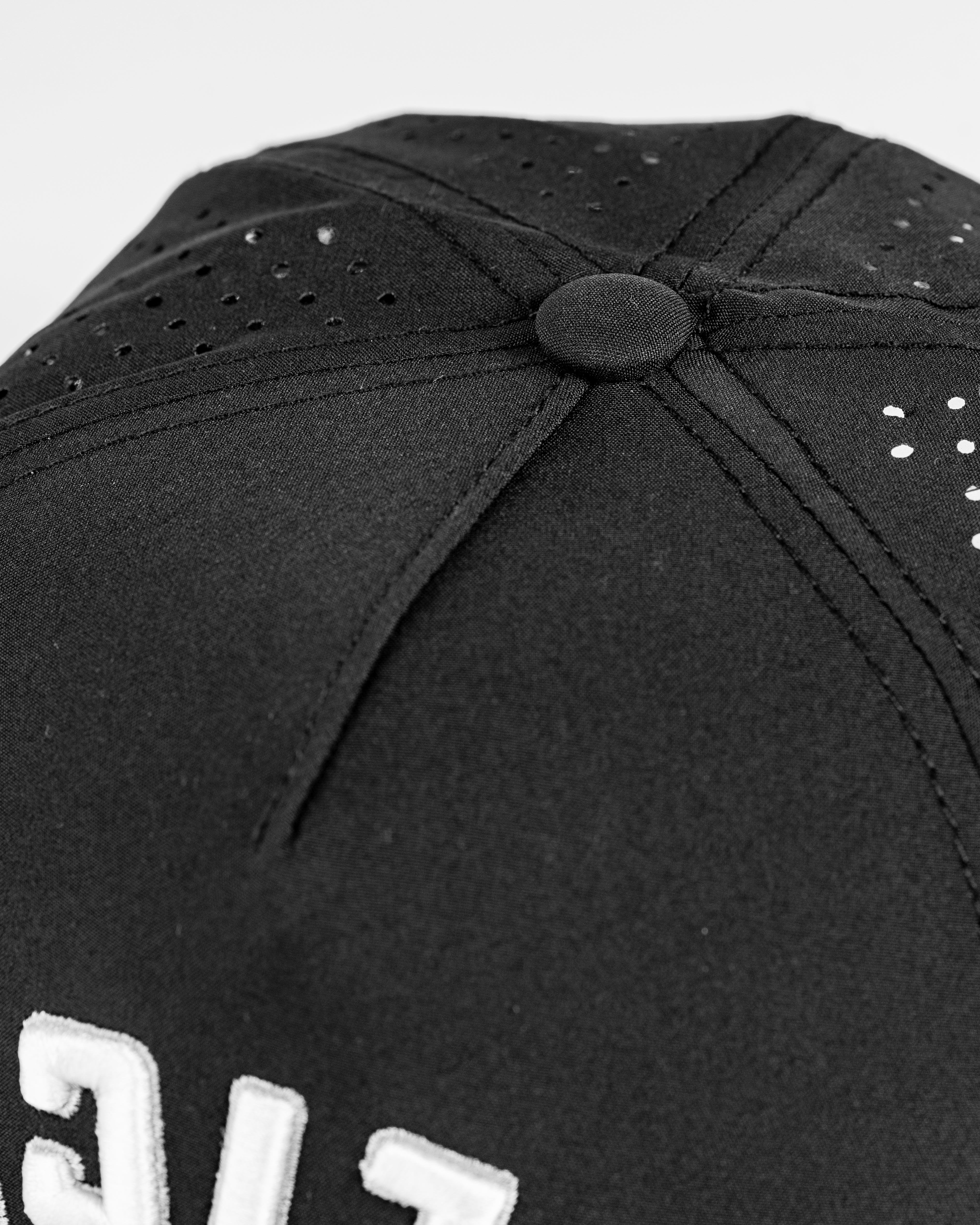 Perforated black rope hat featuring a stylish design and embroidered "Slice" logo for golfers seeking standout apparel.