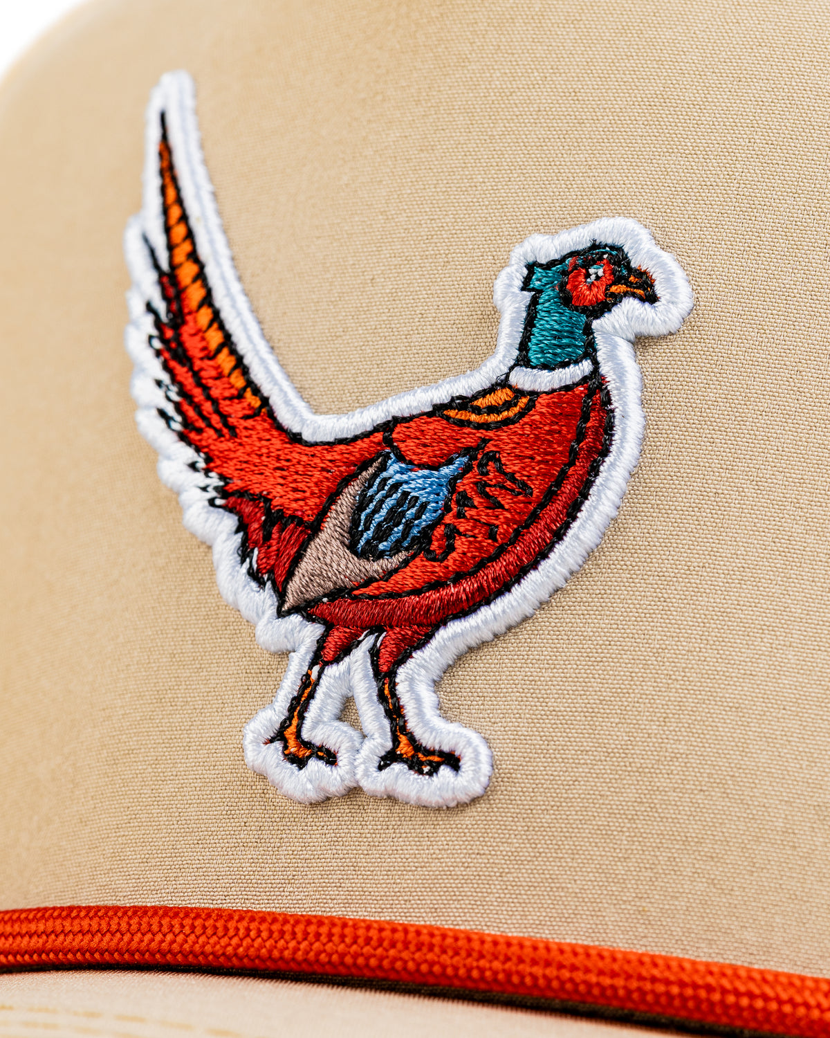 Beige perforated rope hat featuring a colorful embroidered pheasant design on the front.