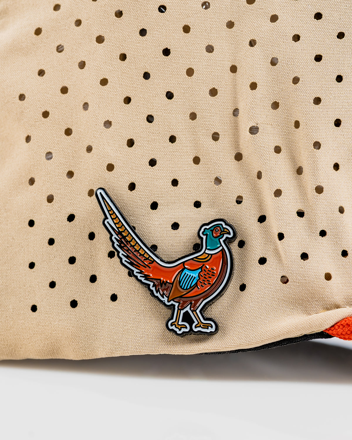 Perforated rope hat featuring a colorful pheasant design, perfect for stylish golfers seeking unique accessories.