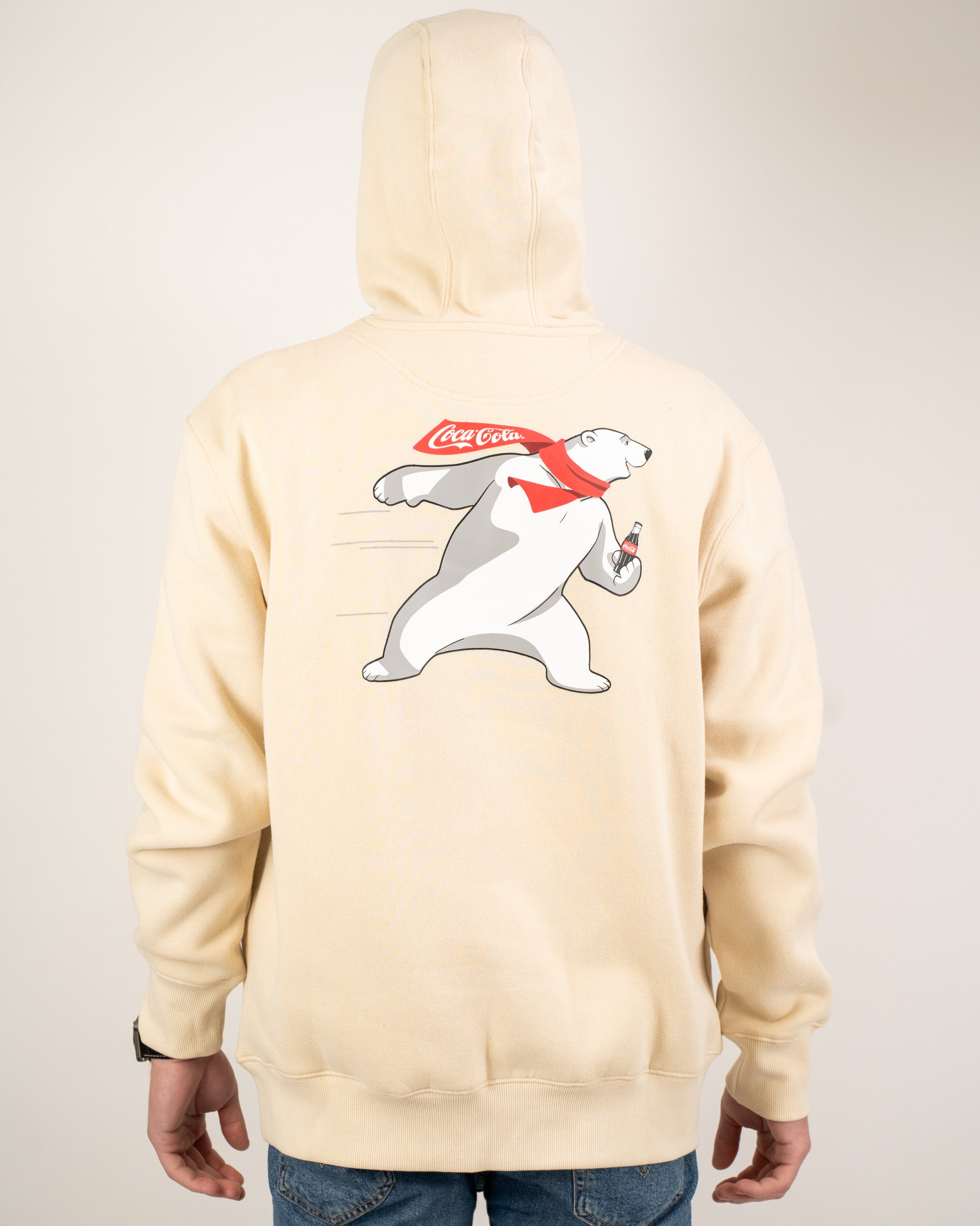 Cream-colored hoodie featuring a playful polar bear graphic with a Coca-Cola logo on the back. Perfect for casual wear.