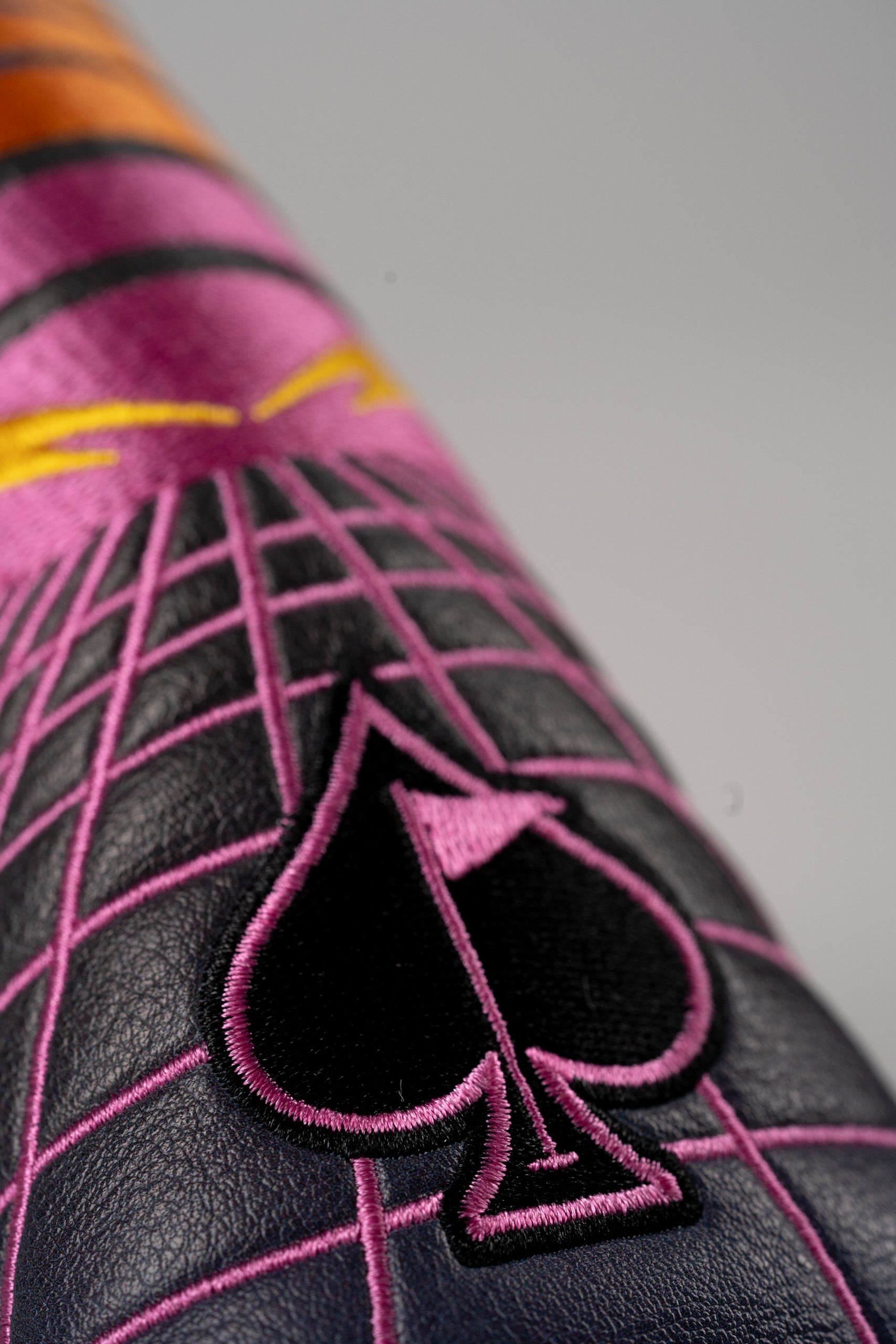 Bold Synthwave Blade Putter Cover featuring vibrant colors and a spade design, perfect for stylish golfers.