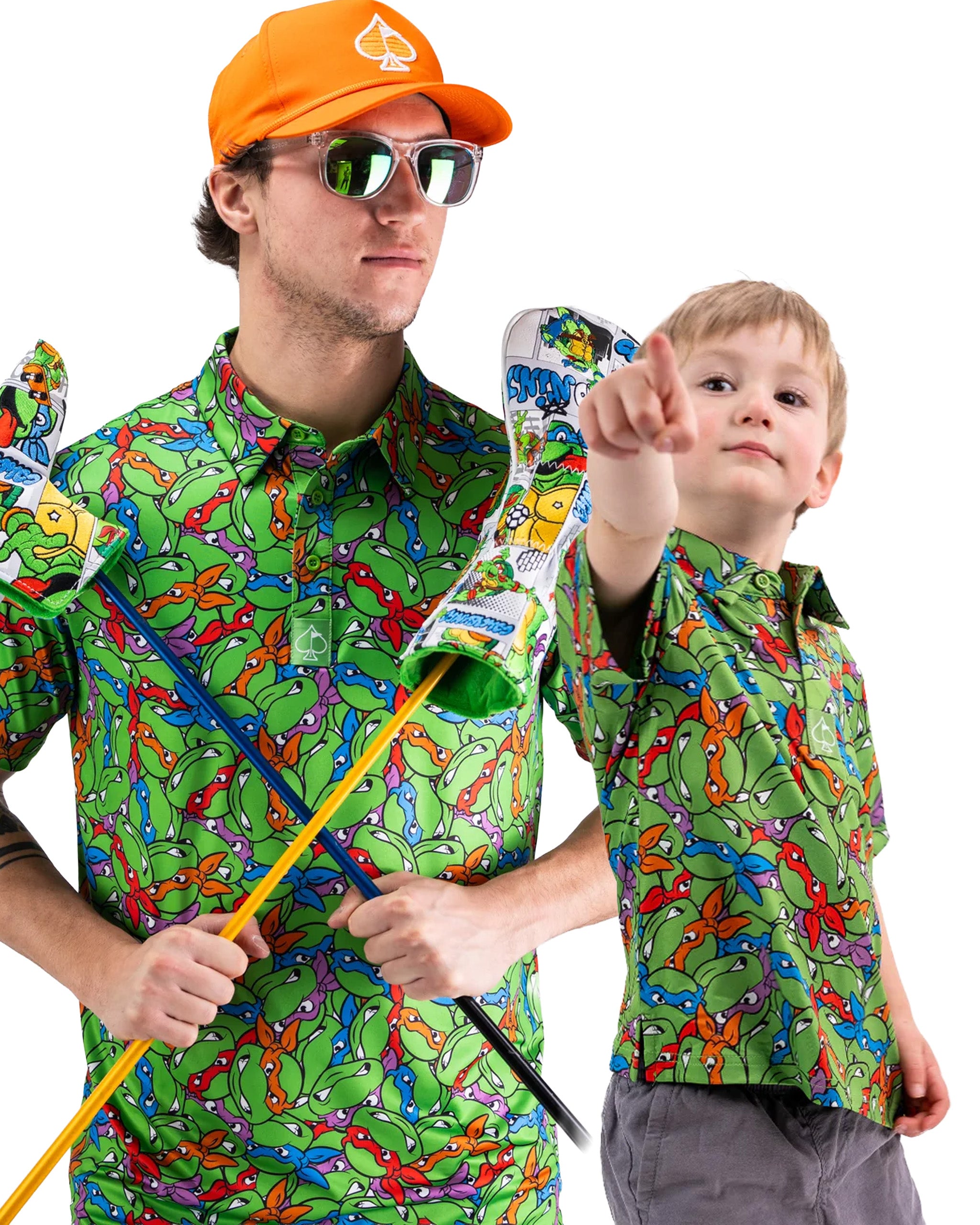 Father and son wearing matching TMNT polos, showcasing vibrant green patterns and playful expressions.