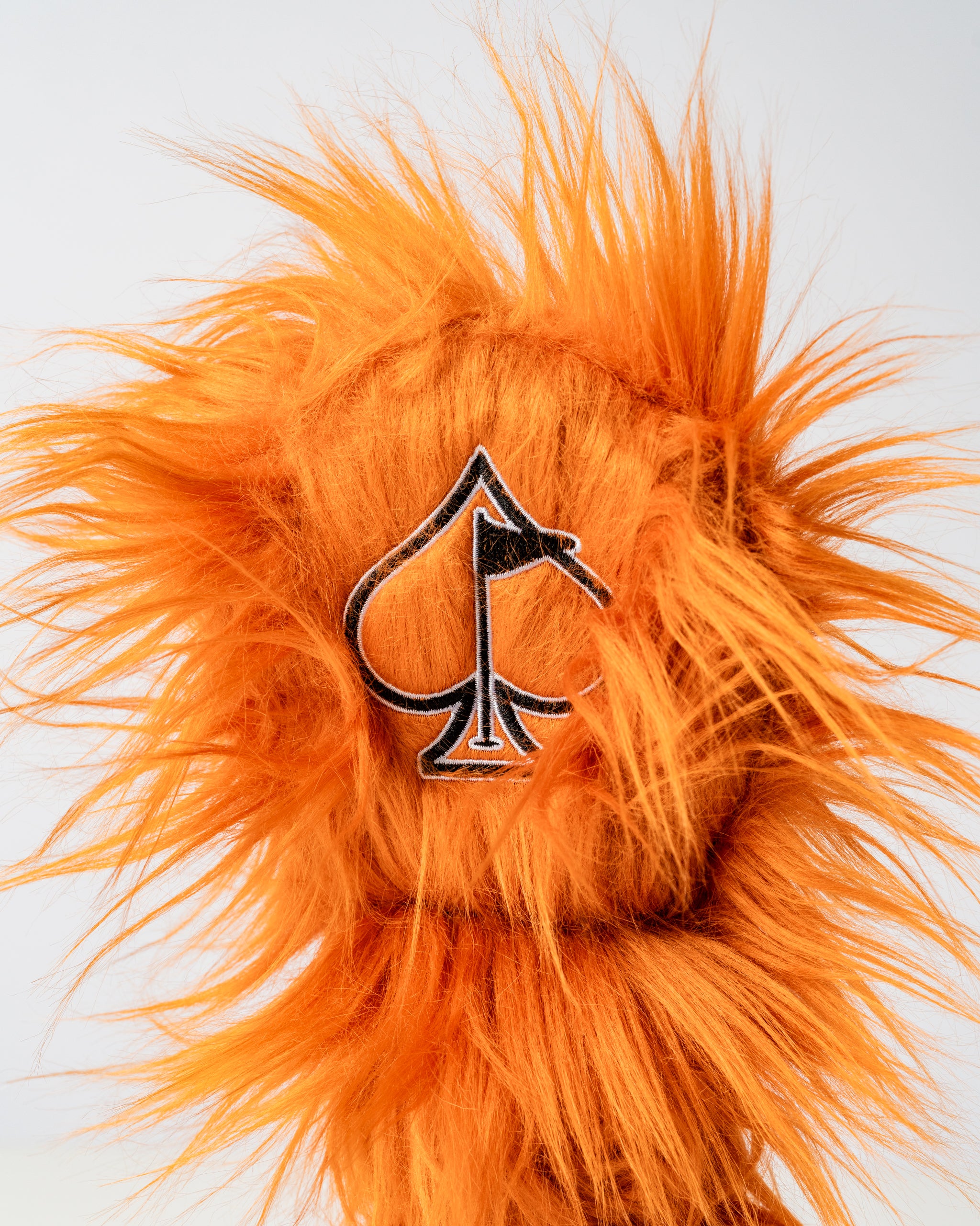 Bold orange tiger headcover with a spade logo, designed to add flair to golf clubs and stand out on the course.