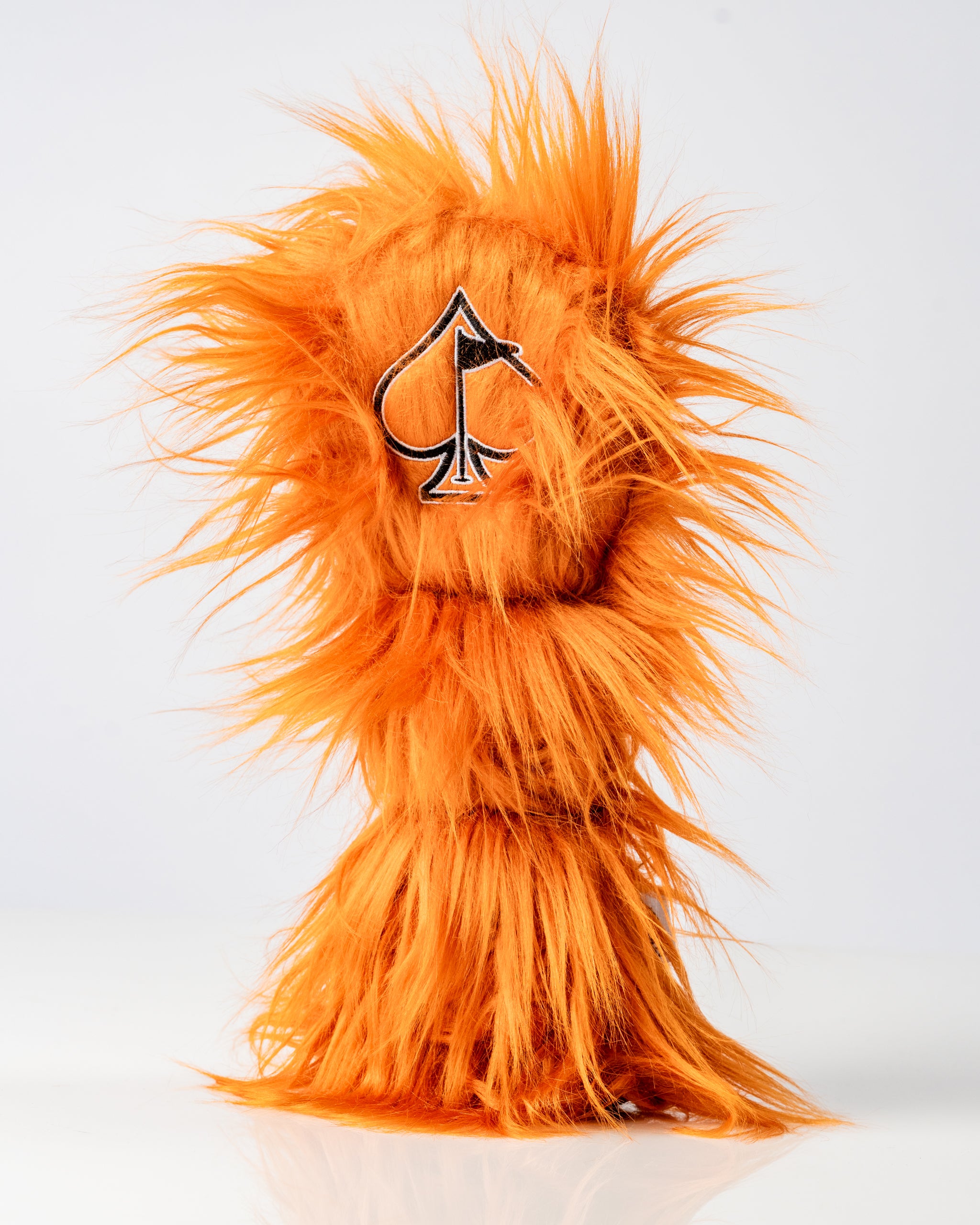 Bold orange tiger-themed fairway cover with a playful furry texture and an embroidered spade logo, perfect for golfers.