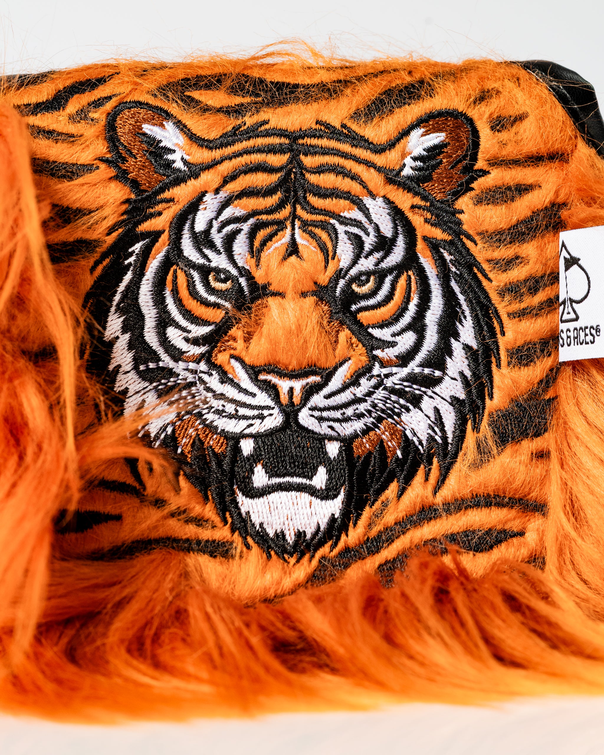 Bold tiger mallet putter cover featuring vibrant orange and black fur with detailed embroidered tiger face design.