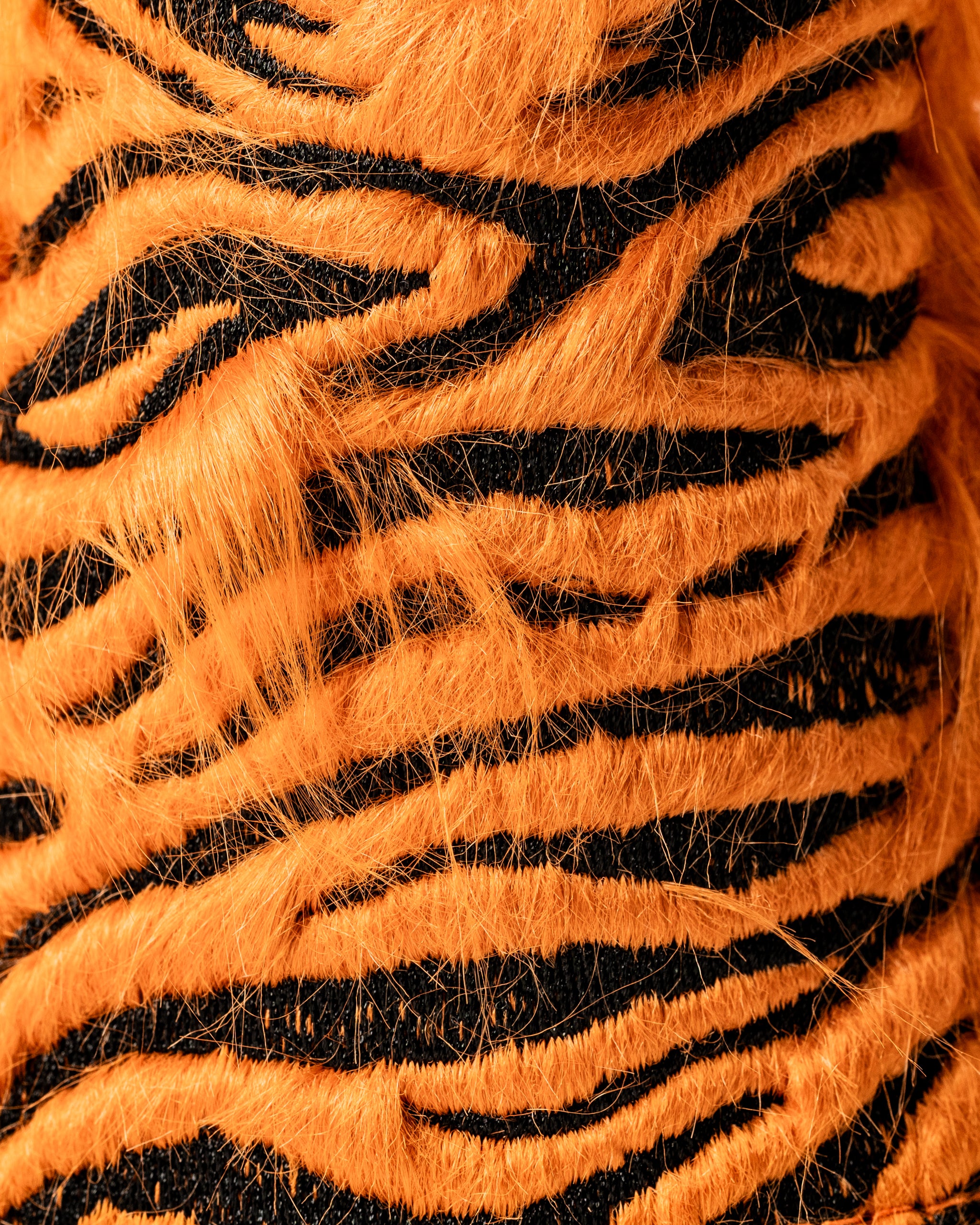 Bold tiger-striped hybrid golf cover featuring vibrant orange and black fur, designed to stand out on the course.