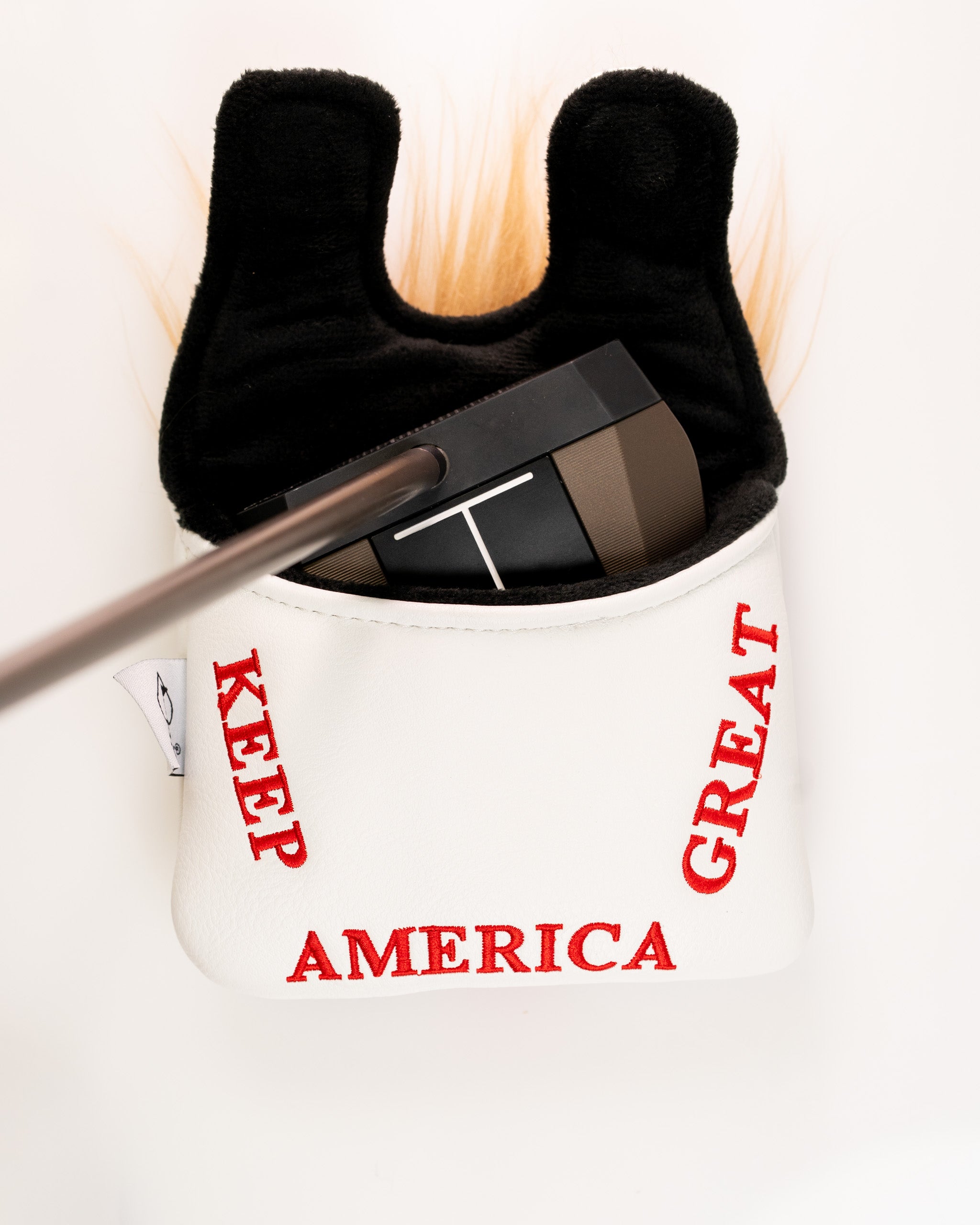 White mallet putter cover featuring "Keep America Great" text in red, with a black interior and a unique design.
