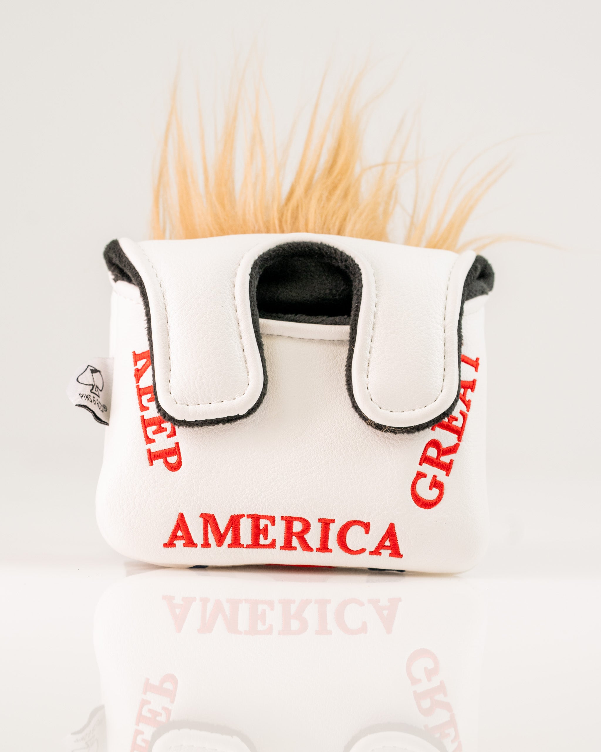 Bold white mallet putter cover featuring "Keep America Great" text and a playful faux fur top, perfect for standout golfers.