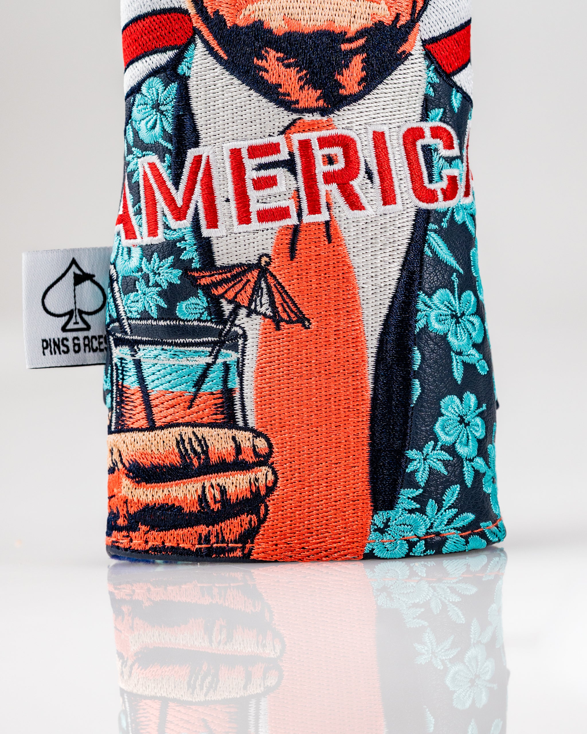 Bold golf headcover set featuring a vibrant design with a character holding a drink, showcasing a patriotic theme.