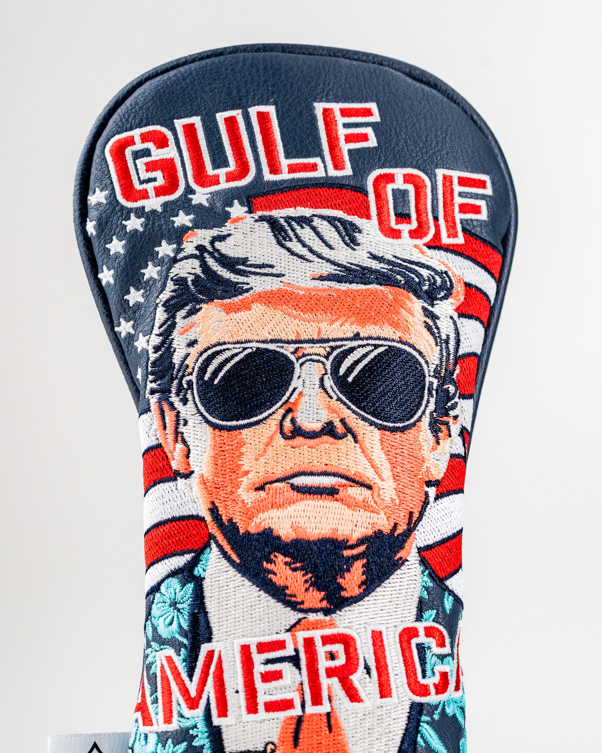Bold golf headcover featuring a stylized portrait of a man in sunglasses with "Gulf of America" text and patriotic design.