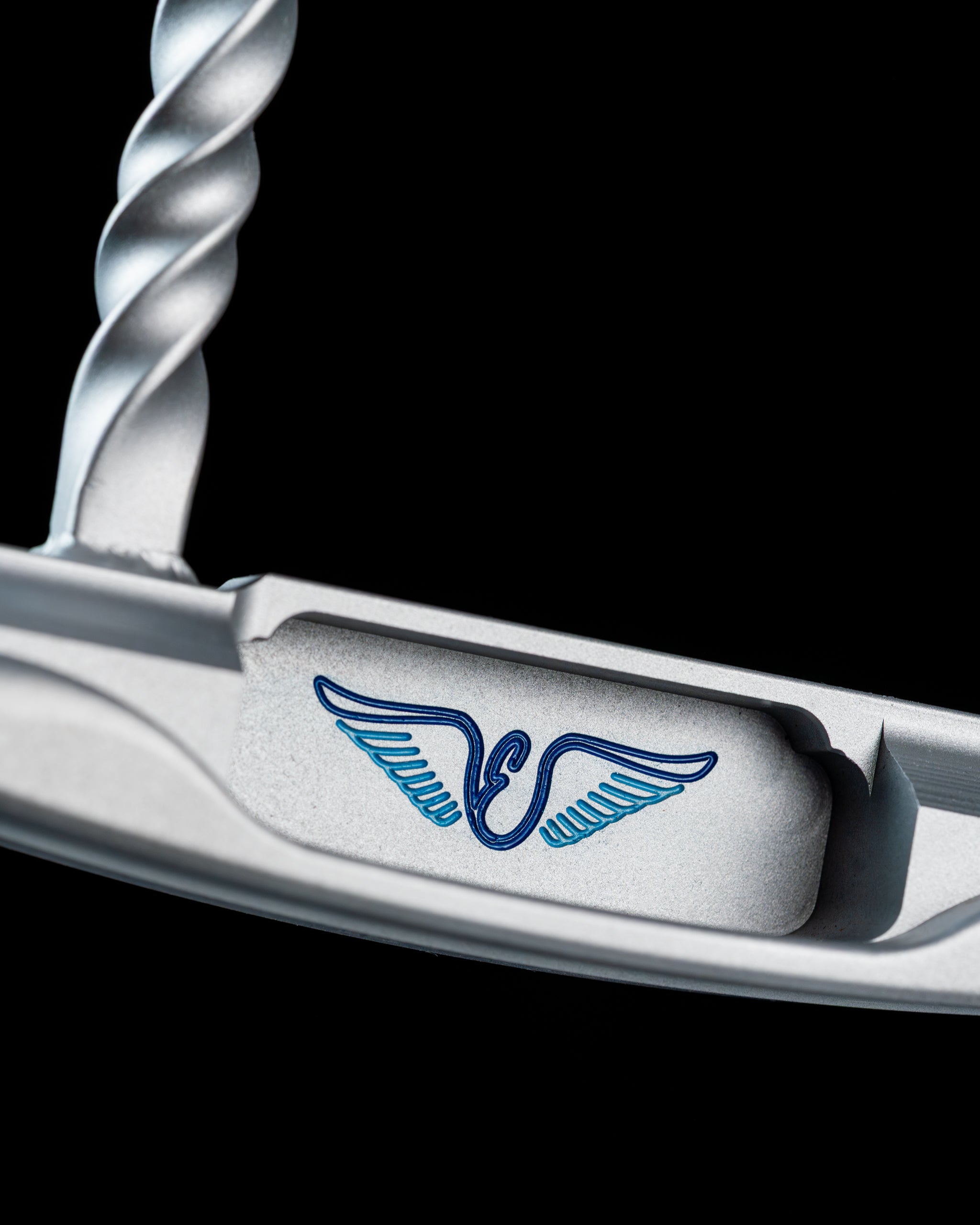 Close-up of the Edel Twister Putter showcasing its unique twisted design and detailed logo, emphasizing precision and style.